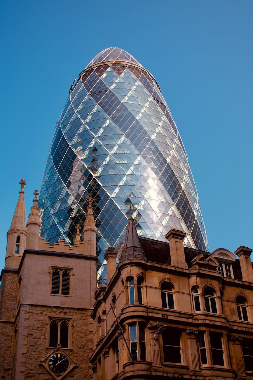 View of London's iconic Gherkin building against a clear blue sky
