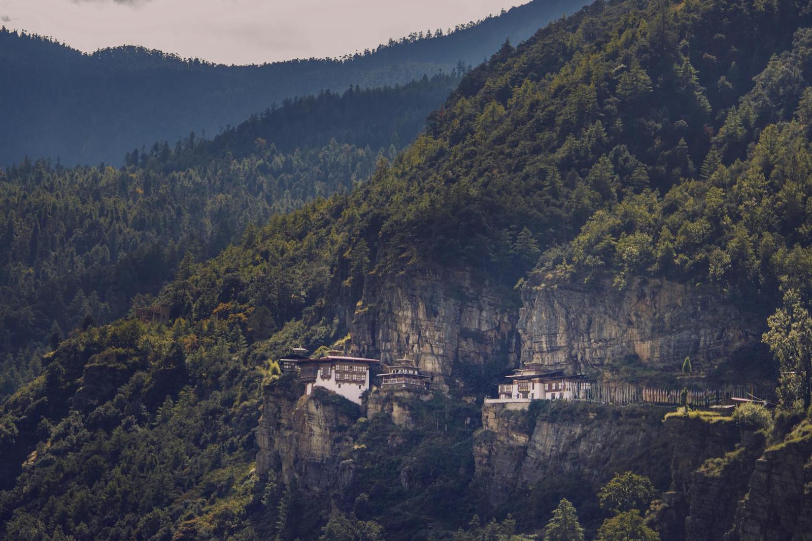 The famous Tiger's Nest Monastery perched on a cliffside in Bhutan's lush mountains