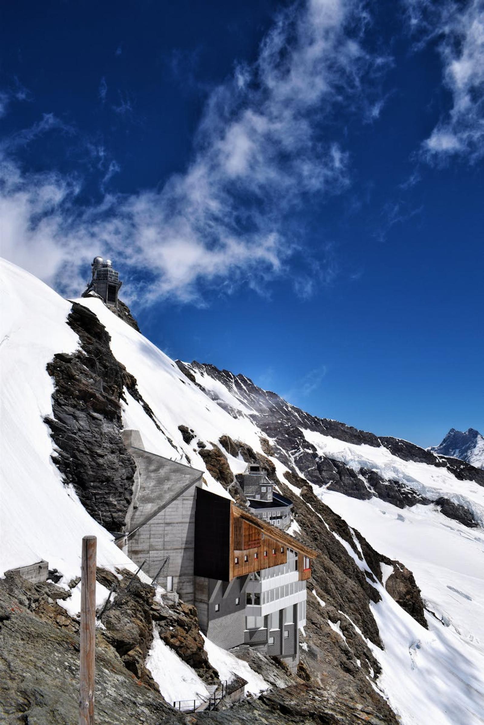 Research station with domed observatories perched on a rocky snowy ridge