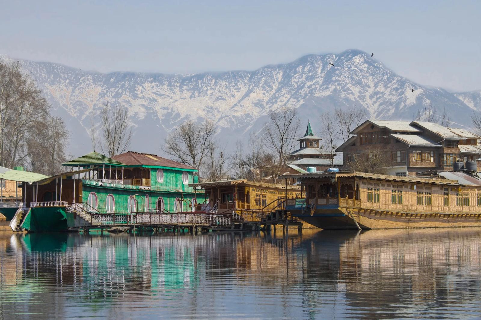 Houseboats moored on Dal Lake below the snow-dusted Zabarwan range, Srinagar