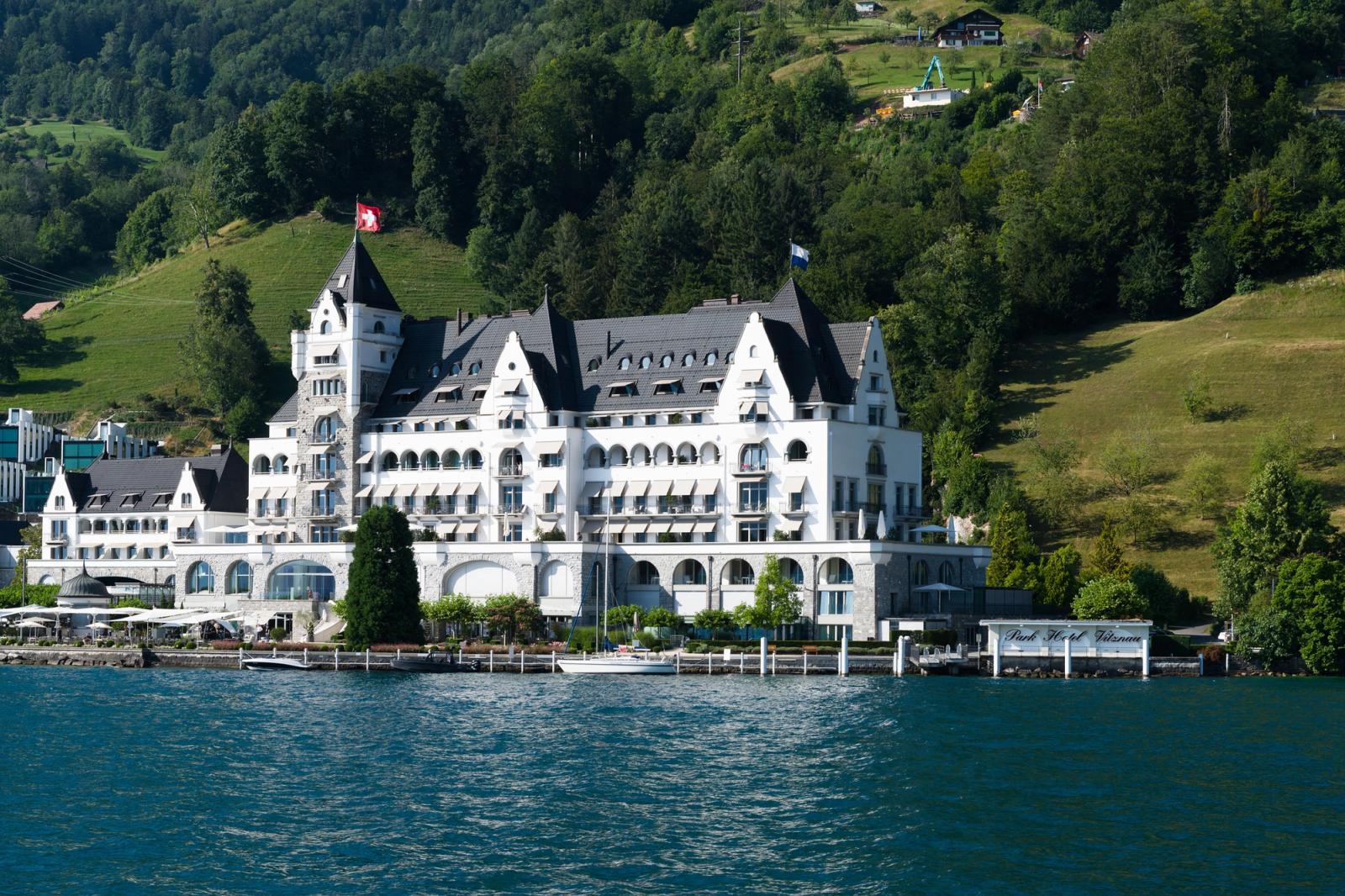 Charming grand hotel by Lake Lucerne, nestled amidst lush hills and forests in Switzerland