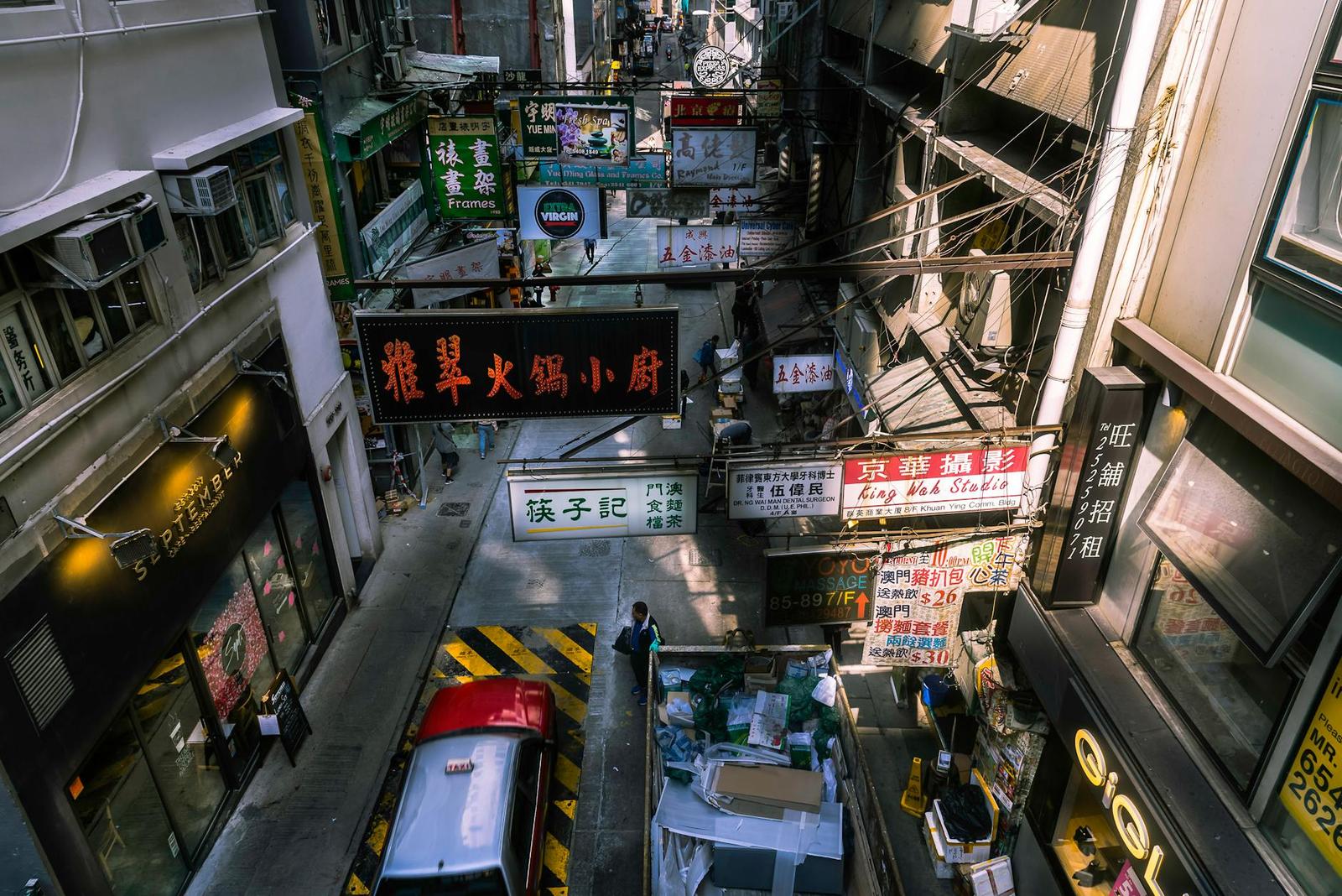 A vibrant view of a busy Hong Kong street market with colorful signage and bustling activity