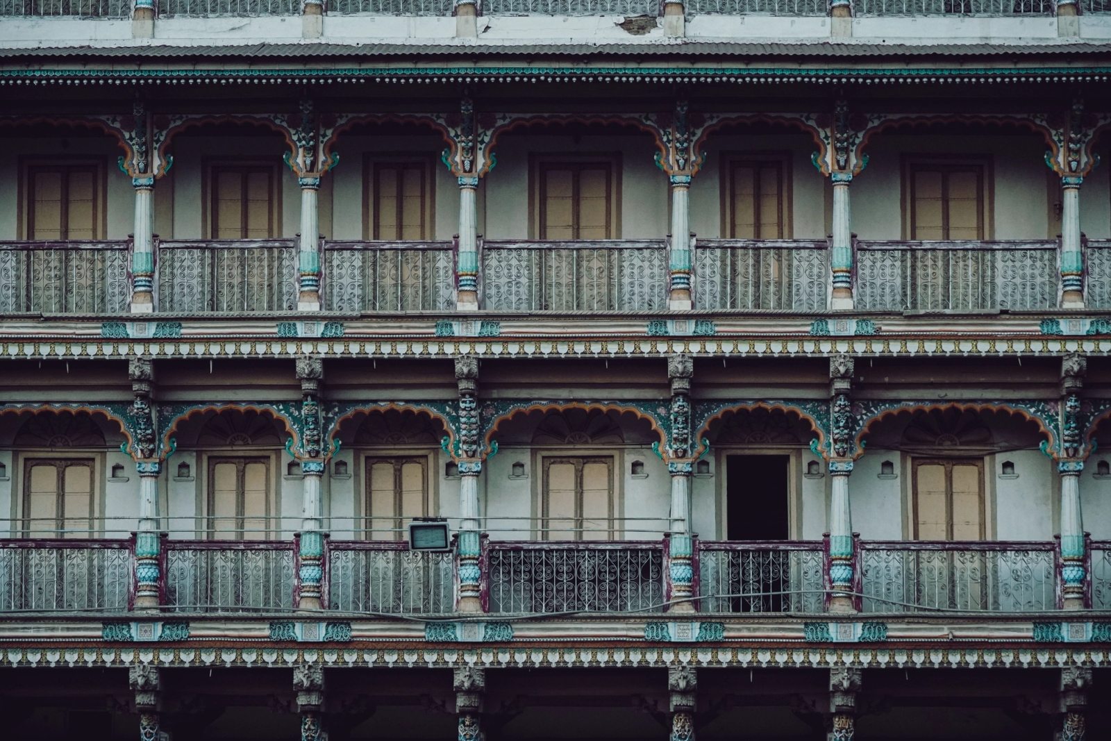 A vibrant multi-story historic facade showcasing traditional architecture in Ahmedabad, India