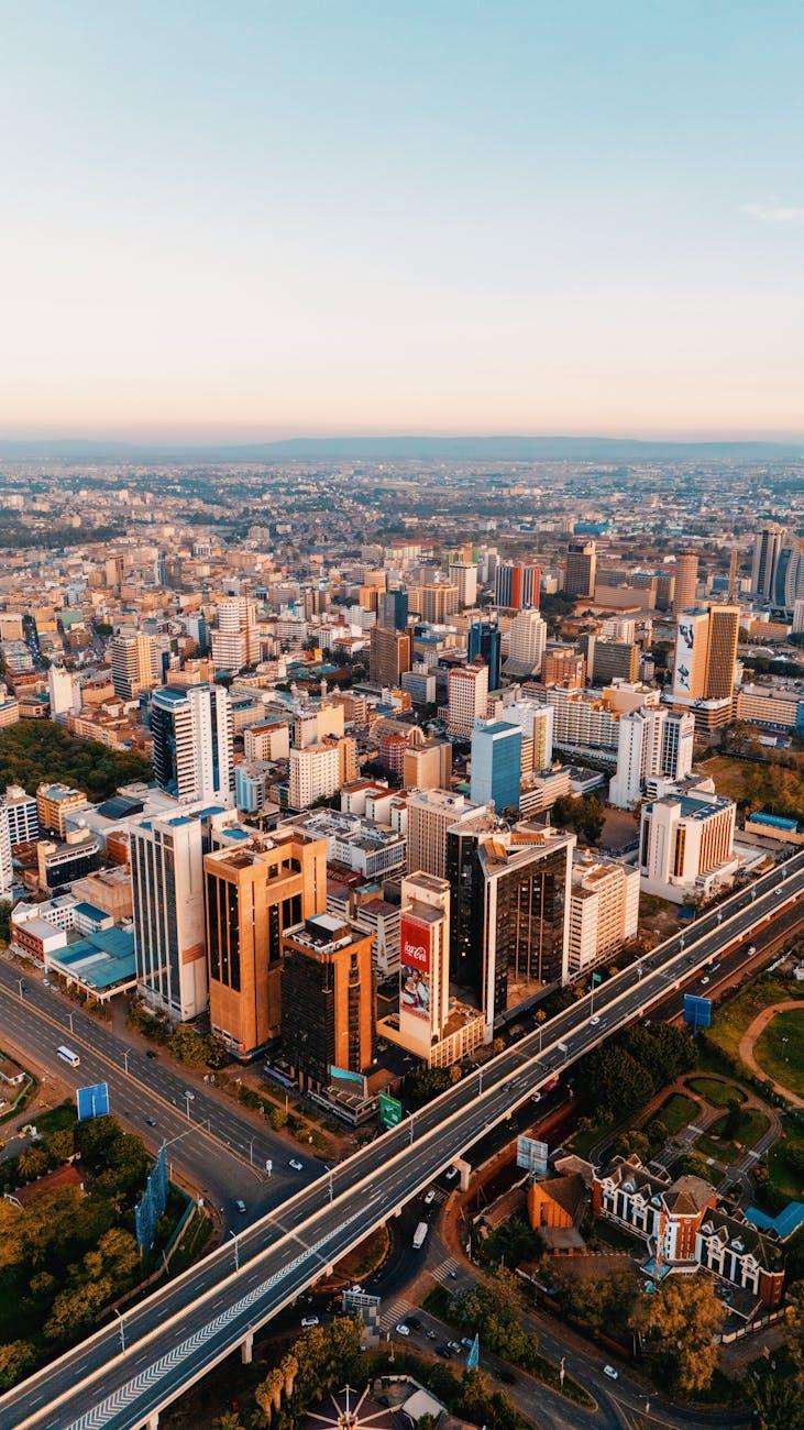Breathtaking aerial view of Nairobi, Kenya's skyline with modern skyscrapers and roads at sunset