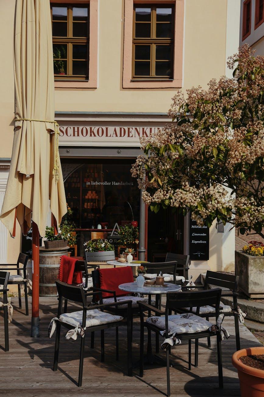 Charming outdoor patio seating in a German cafe with tables and chairs under a parasol
