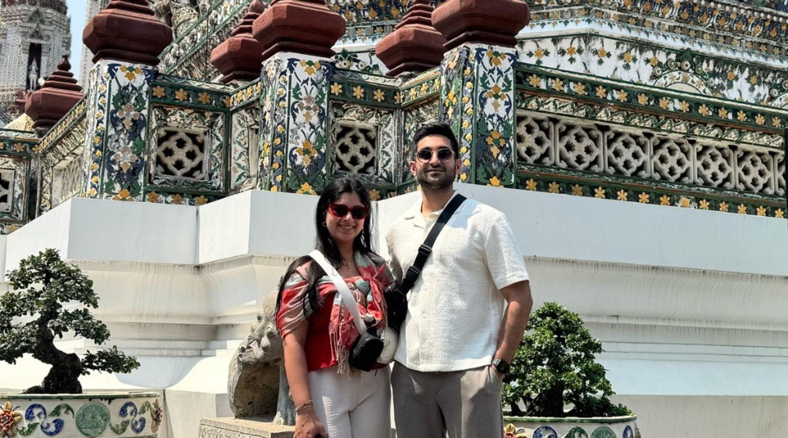 Couple posing in front of temple 