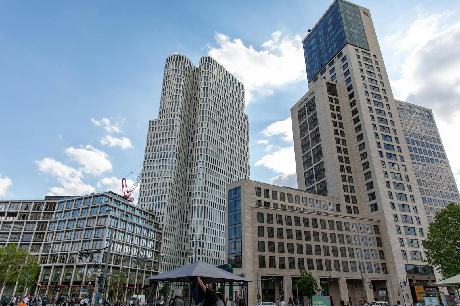 A cluster of modern high-rise towers around a paved city square