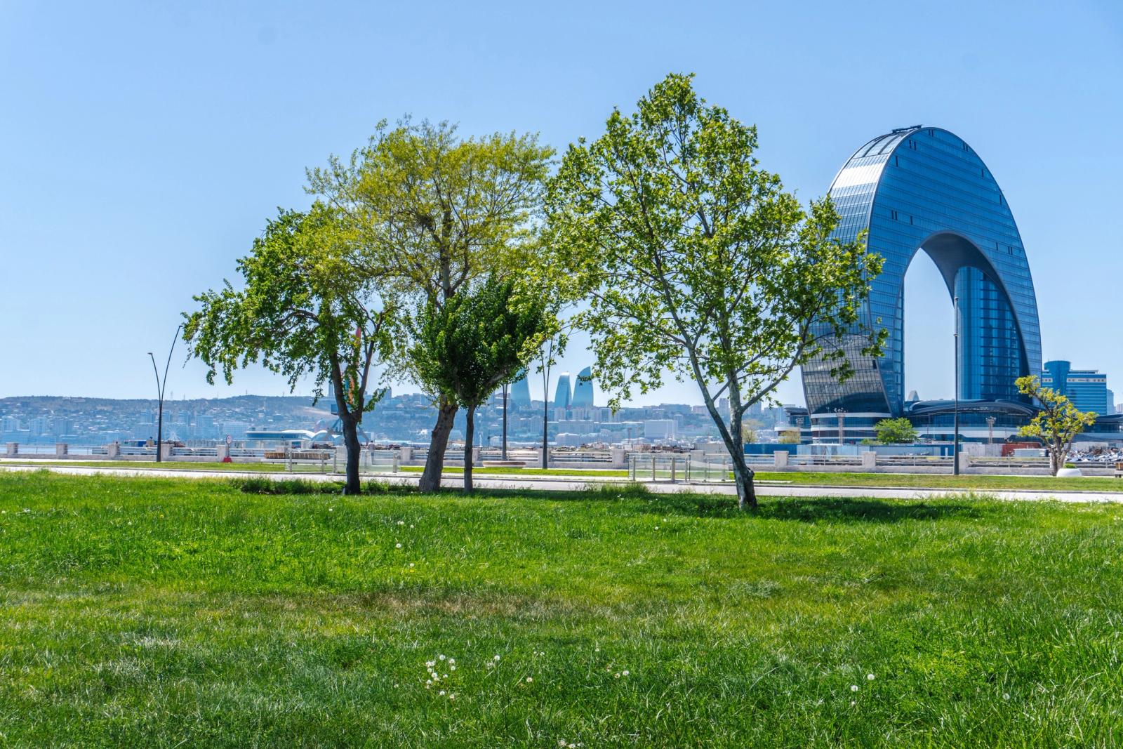 View of modern architecture and lush park in Baku, Azerbaijan on a sunny day