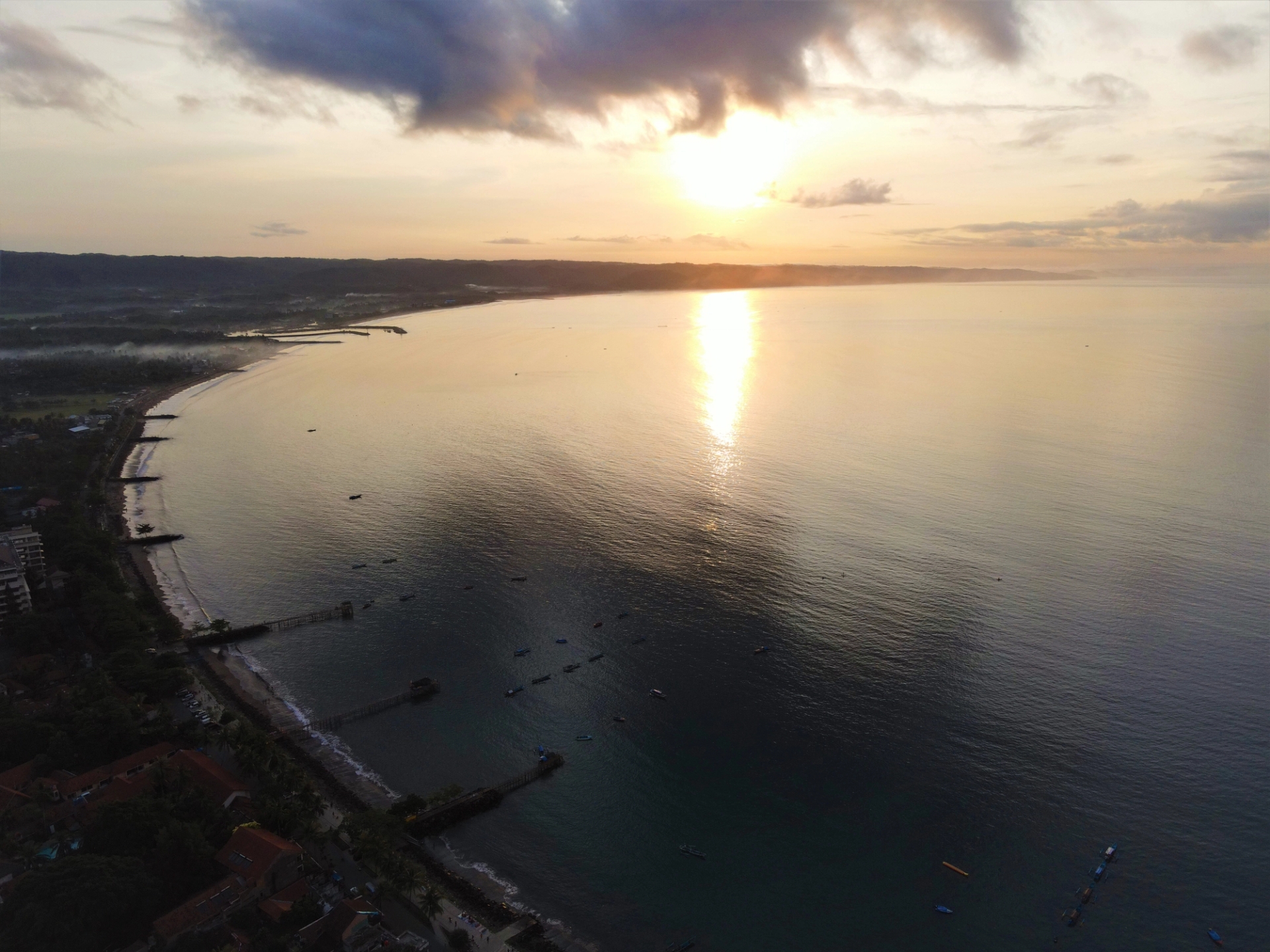 Stunning aerial view of sunrise over Pangandaran, Indonesia coastline, capturing the serene sea and horizon