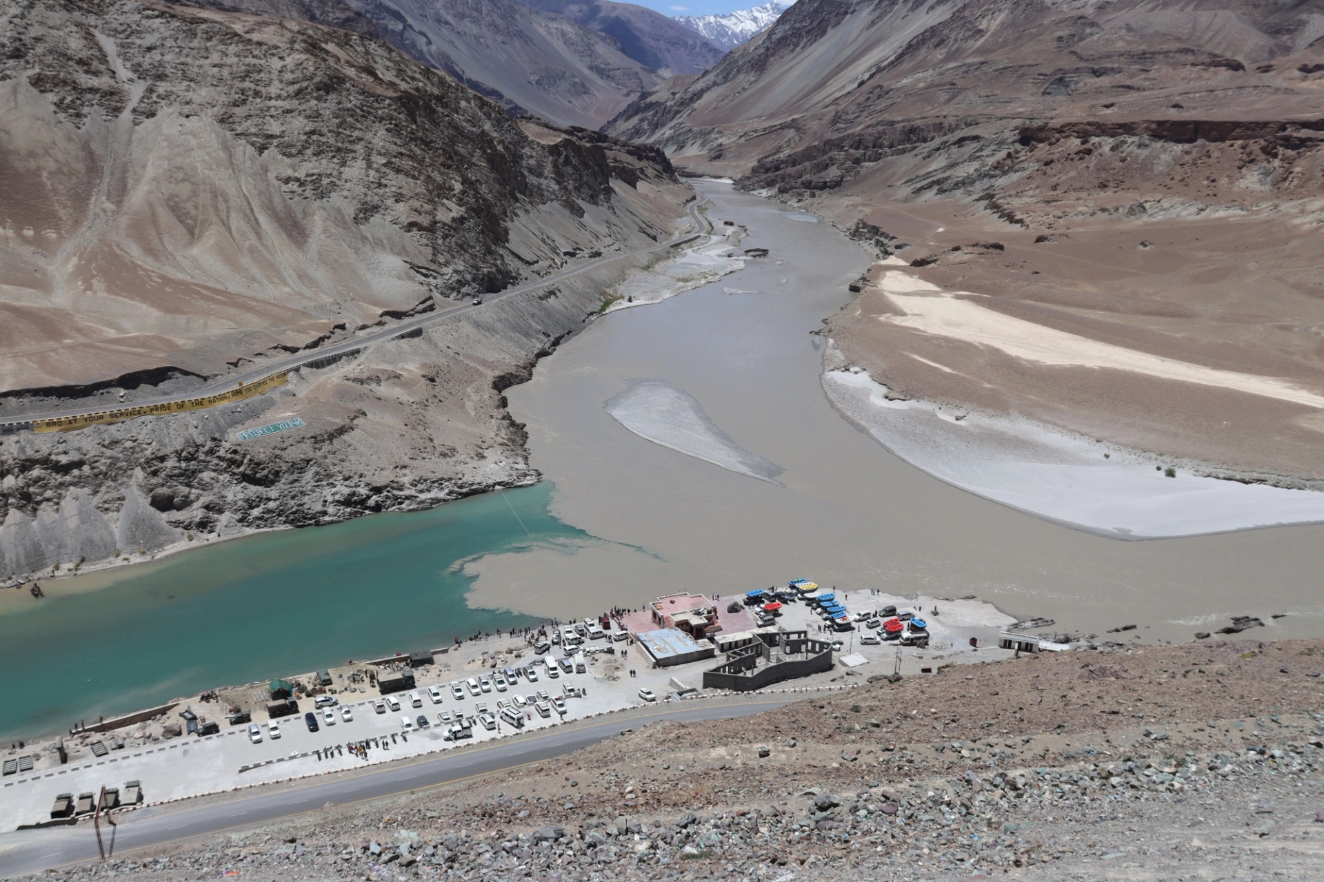 A breathtaking aerial view of a river confluence near Leh surrounded by rugged mountains