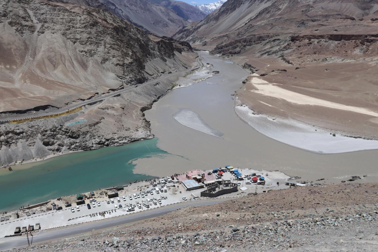 A breathtaking aerial view of a river confluence near Leh surrounded by rugged mountains