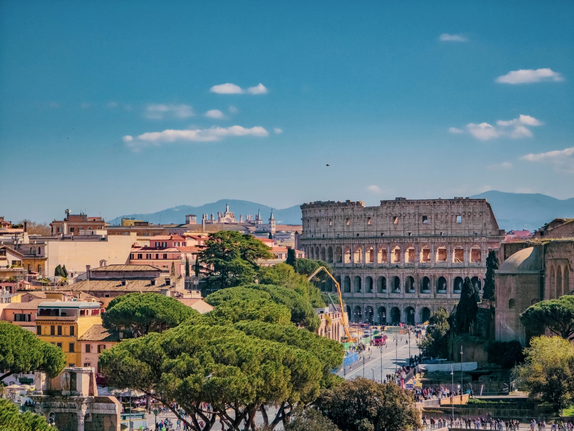 A breathtaking view of Rome featuring the iconic Colosseum on a sunny day