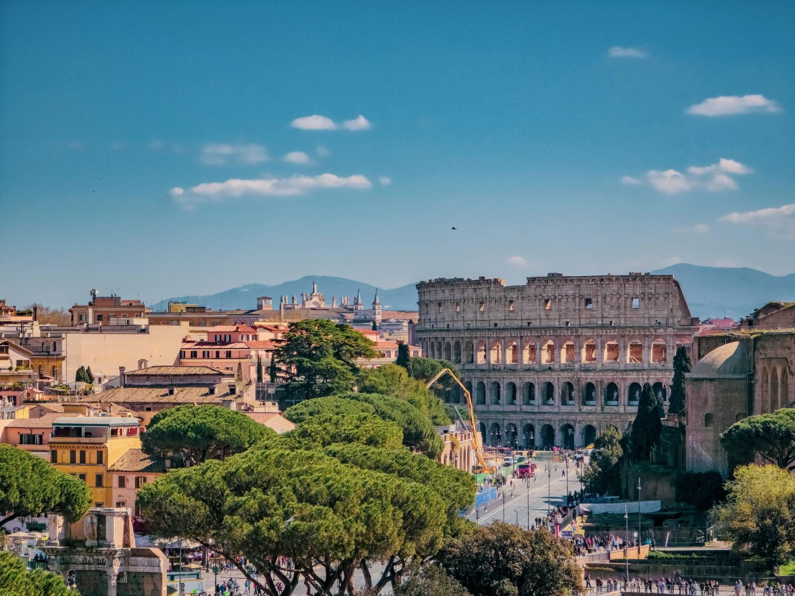 A breathtaking view of Rome featuring the iconic Colosseum on a sunny day