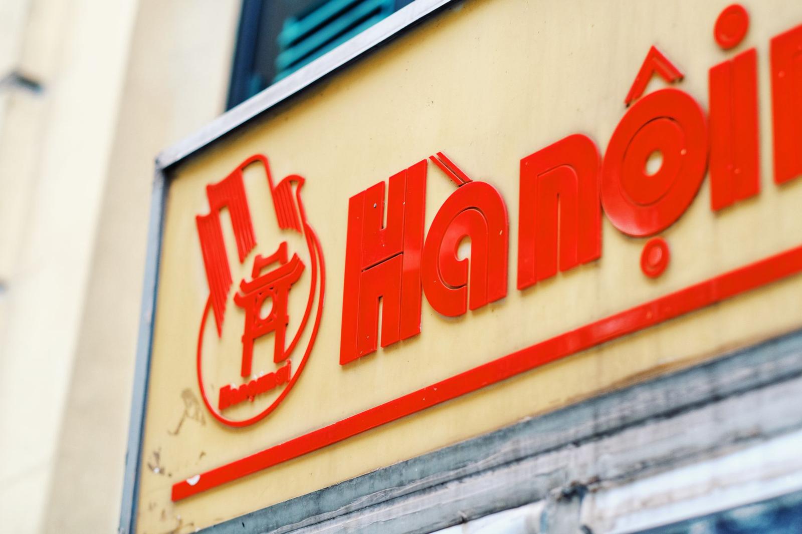 Close-up of a red Hanoi sign on a building wall, vibrant urban setting