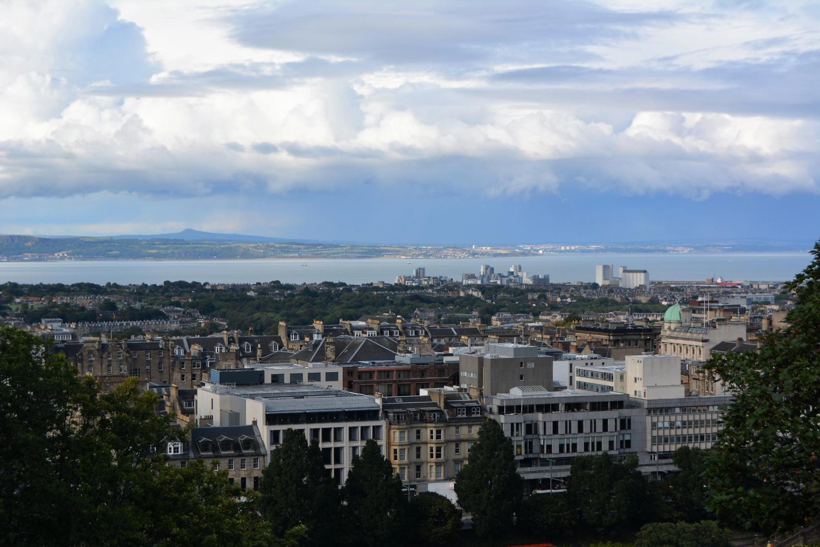 Panoramic skyline of Edinburgh with the Firth of Forth in the background on a cloudy day
