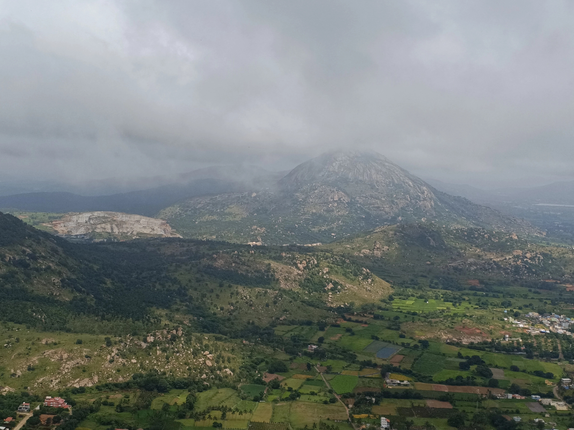 A breathtaking aerial view of lush green valleys and mist-covered mountains in India during the monsoon