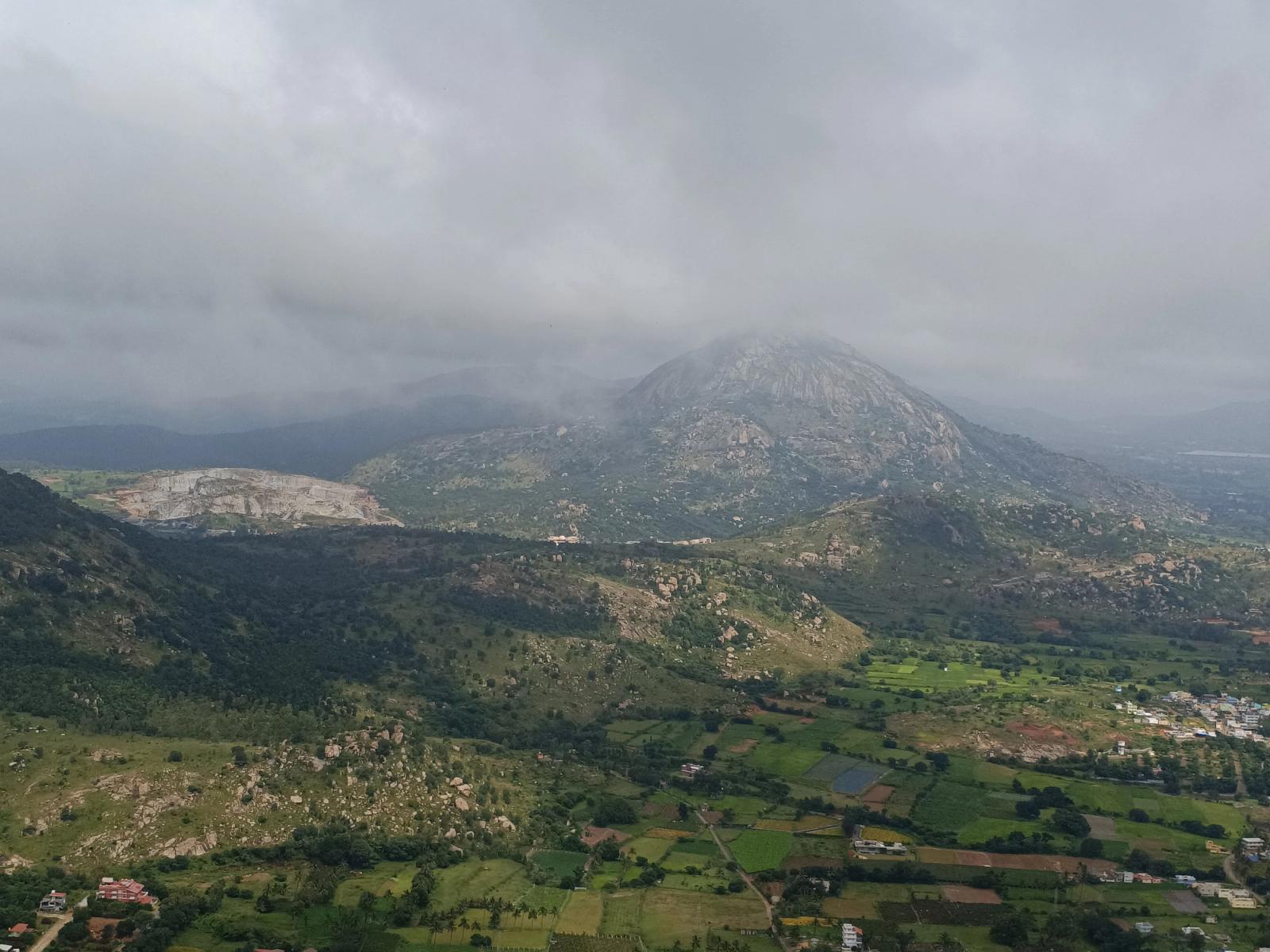 A breathtaking aerial view of lush green valleys and mist-covered mountains in India during the monsoon