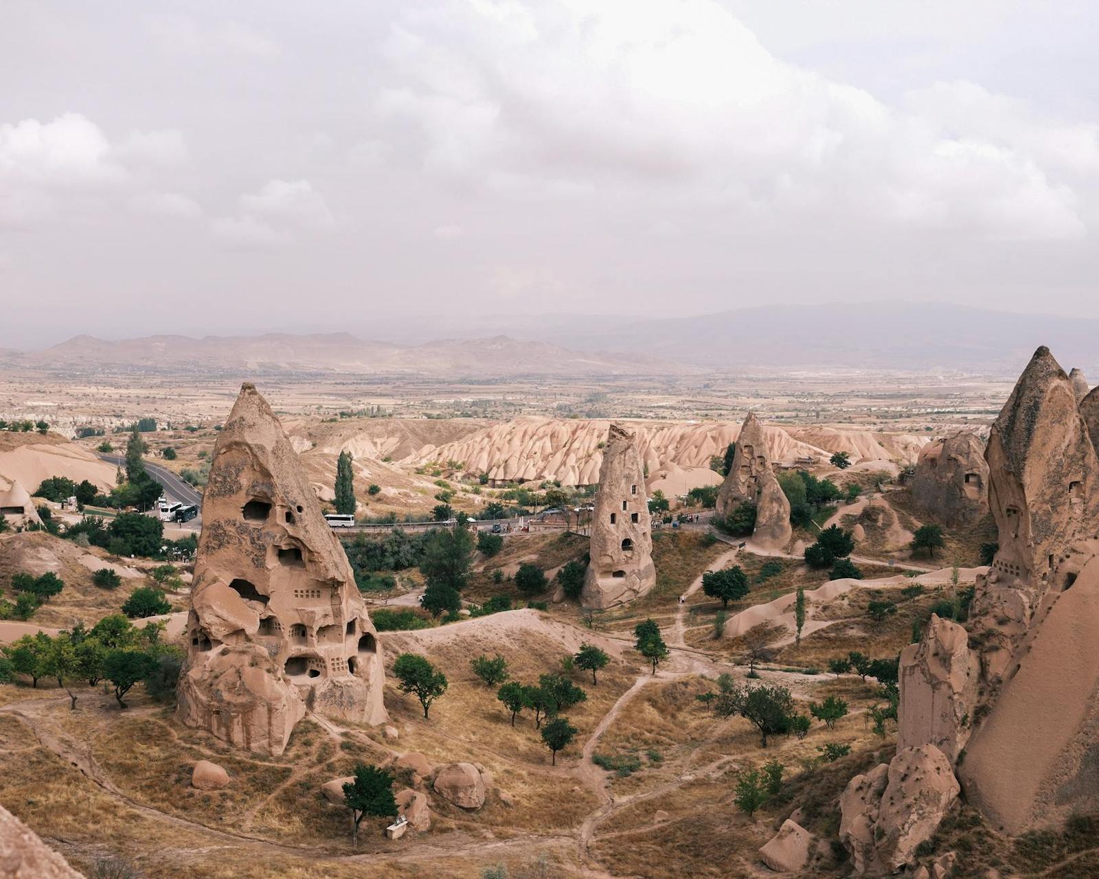 Valley of cone-shaped rock formations dotted with carved dwellings