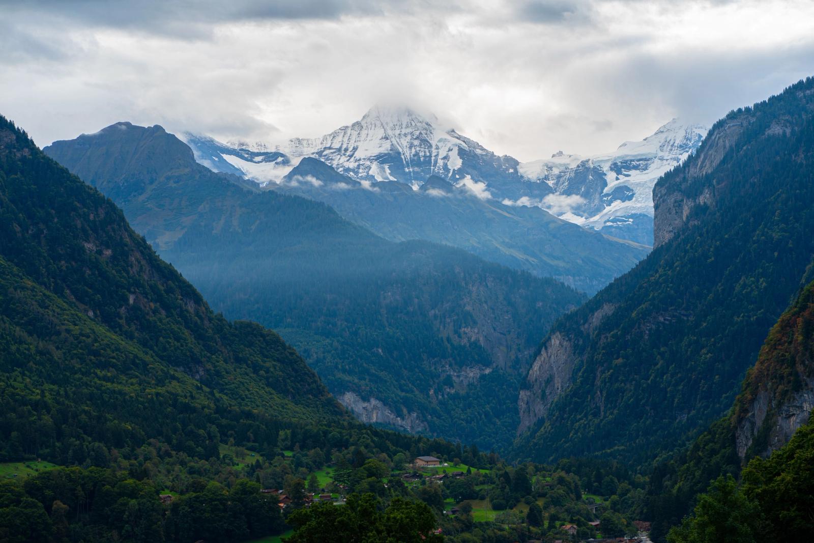 Breathtaking view of snow-capped Swiss Alps with lush green valleys below