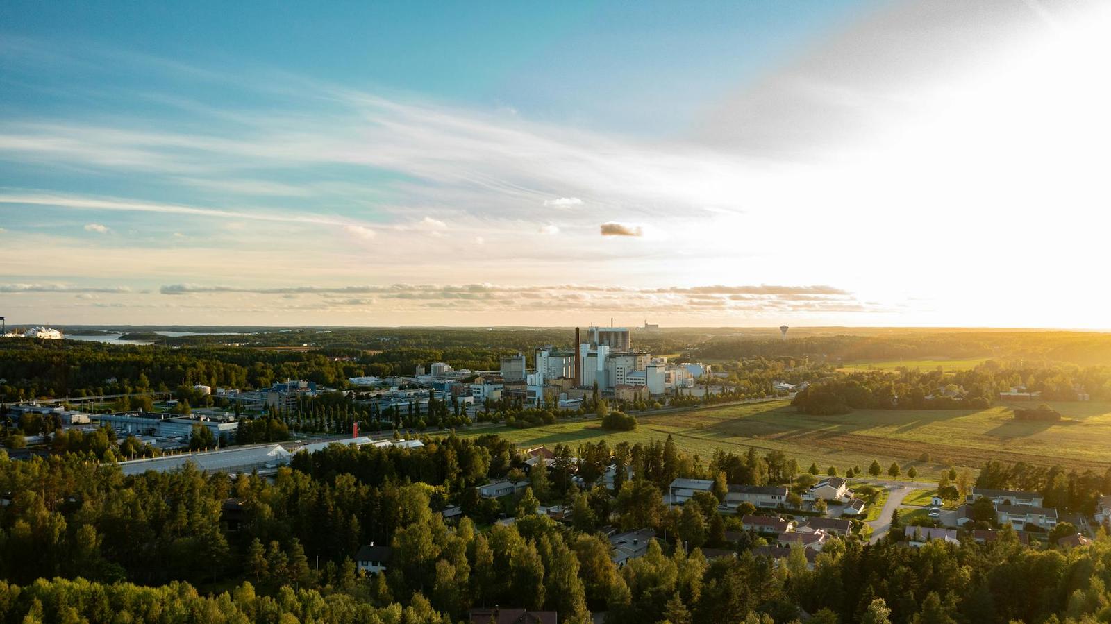 Aerial view of a small town spread among fields at sunset
