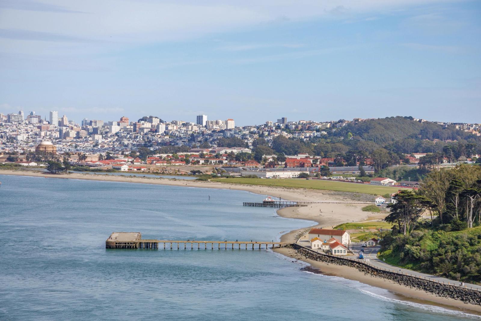 A panoramic view of San Francisco Bay with the city skyline and greenery
