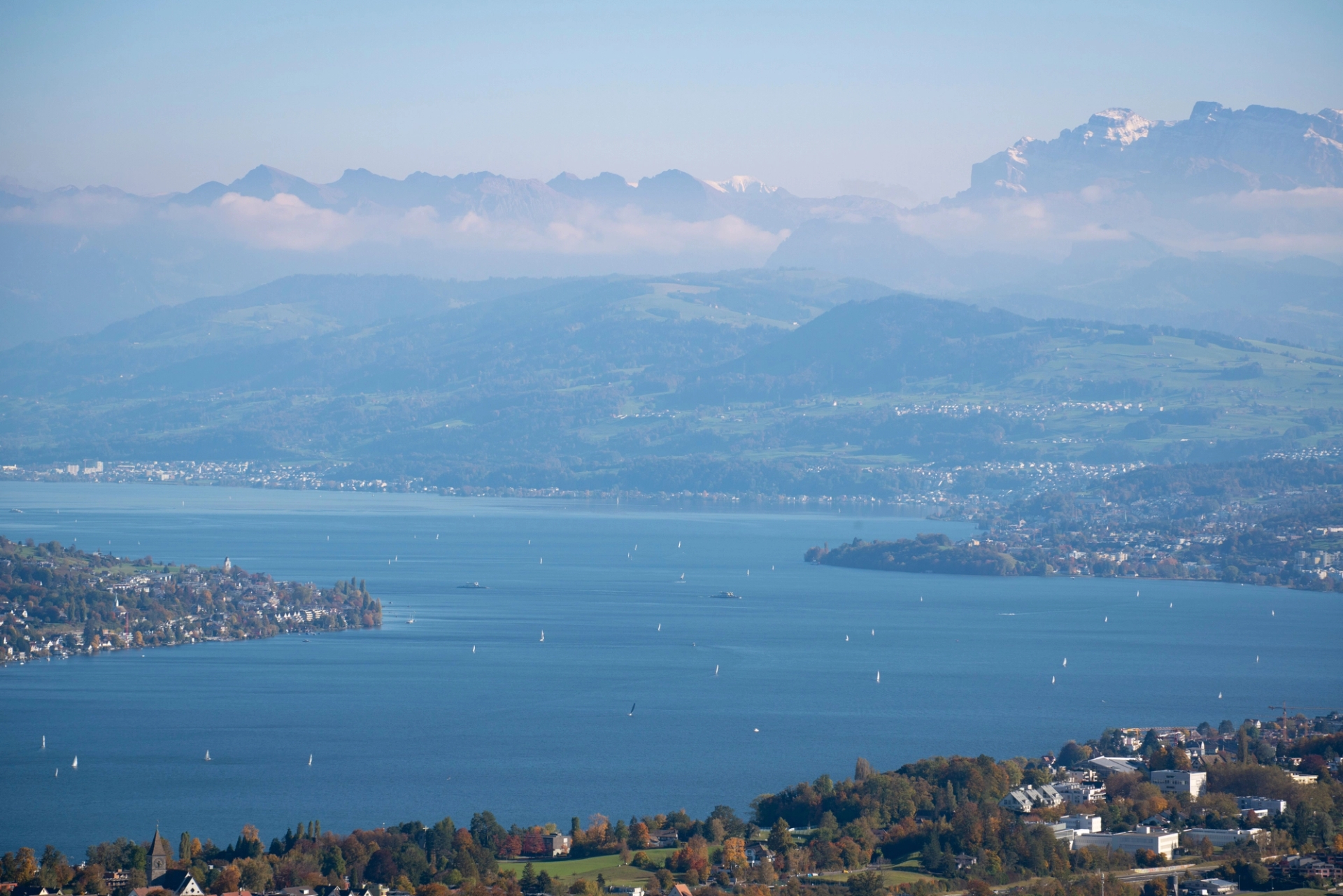 Picturesque aerial view of Lake Zurich surrounded by mountains and sailboats