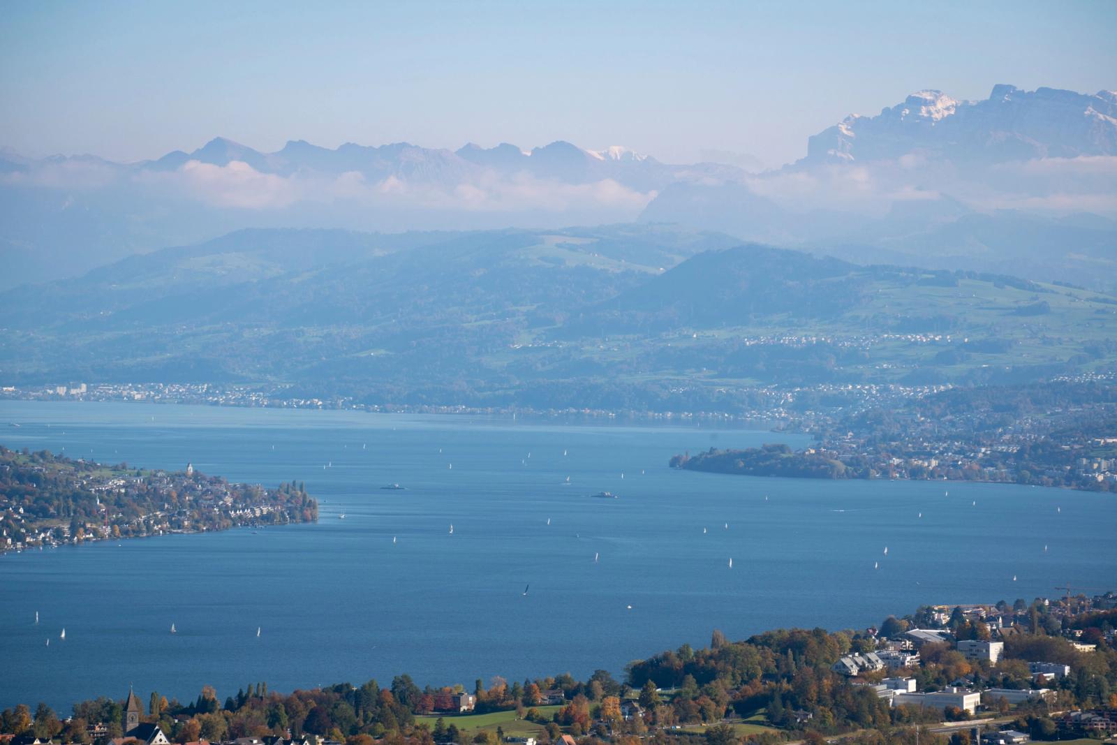 Picturesque aerial view of Lake Zurich surrounded by mountains and sailboats