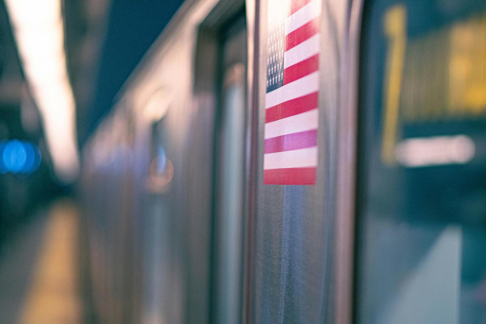 A close-up of an American flag decal on the side of a parked train car