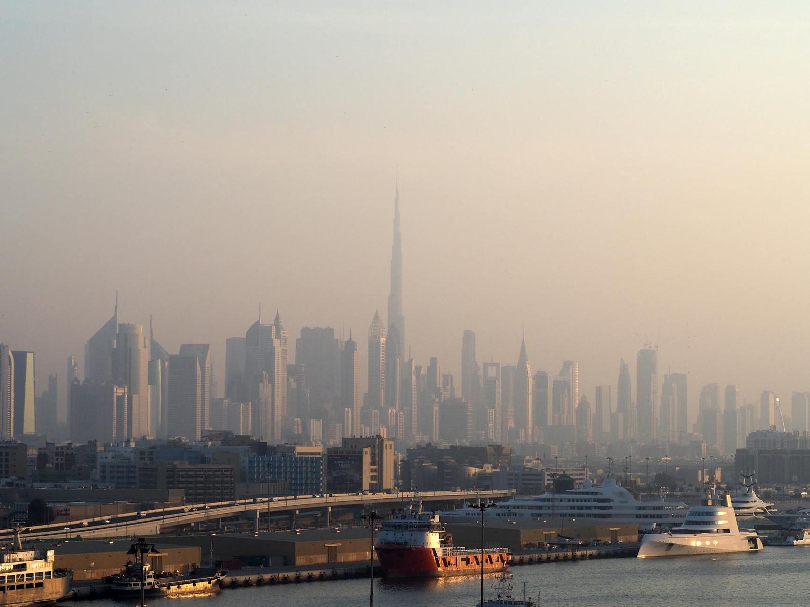 Captivating view of Dubai skyline featuring the iconic Burj Khalifa with a backdrop of a serene coastal scene