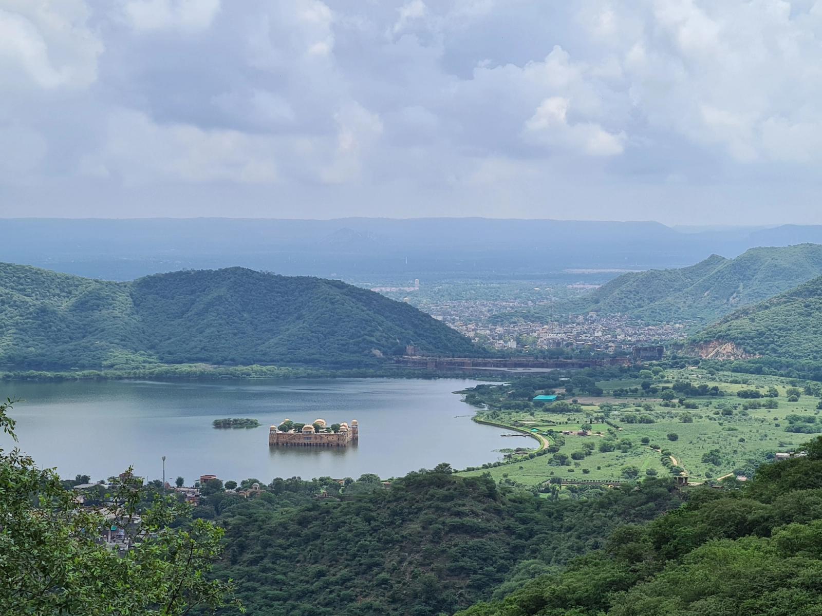 Stunning aerial view of Jal Mahal amidst Man Sagar Lake, Jaipur, surrounded by lush hills