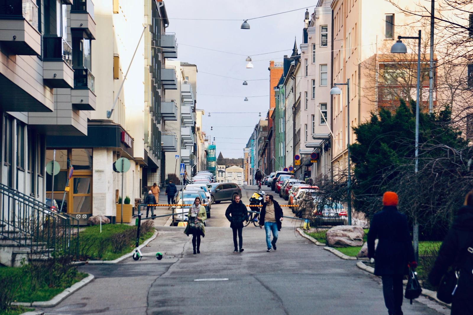 Vibrant street scene in Helsinki, Finland, showcasing pedestrians amidst urban architecture