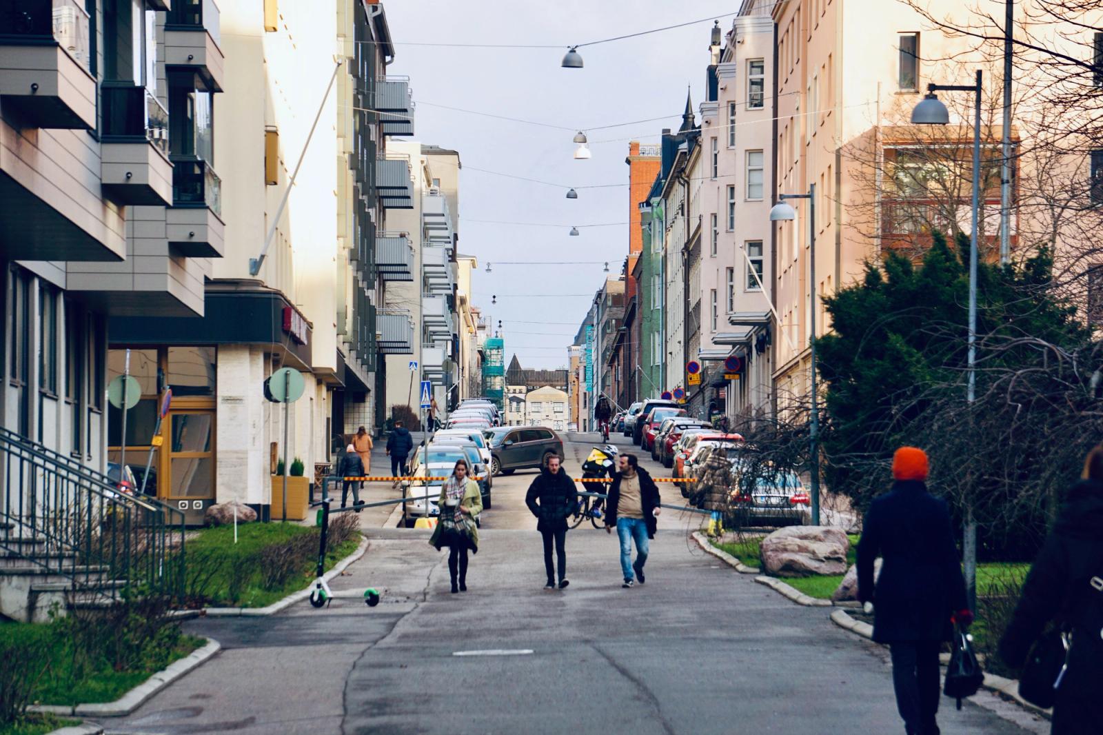Vibrant street scene in Helsinki, Finland, showcasing pedestrians amidst urban architecture