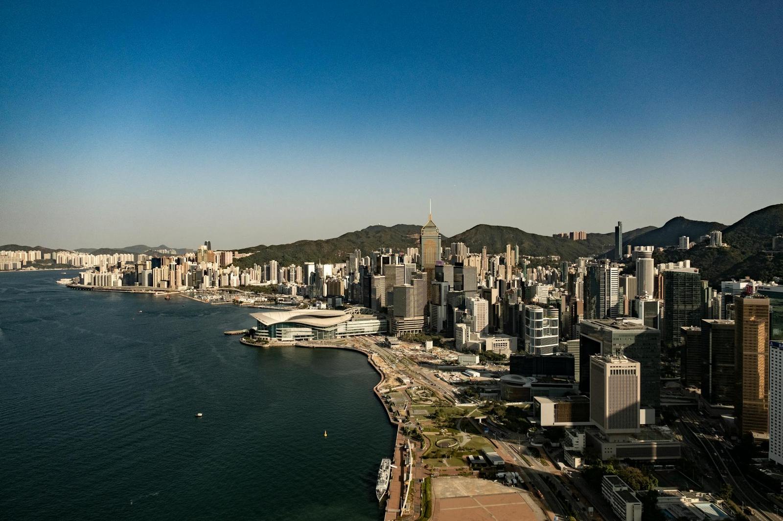 A coastal skyline of skyscrapers along a curving harbour