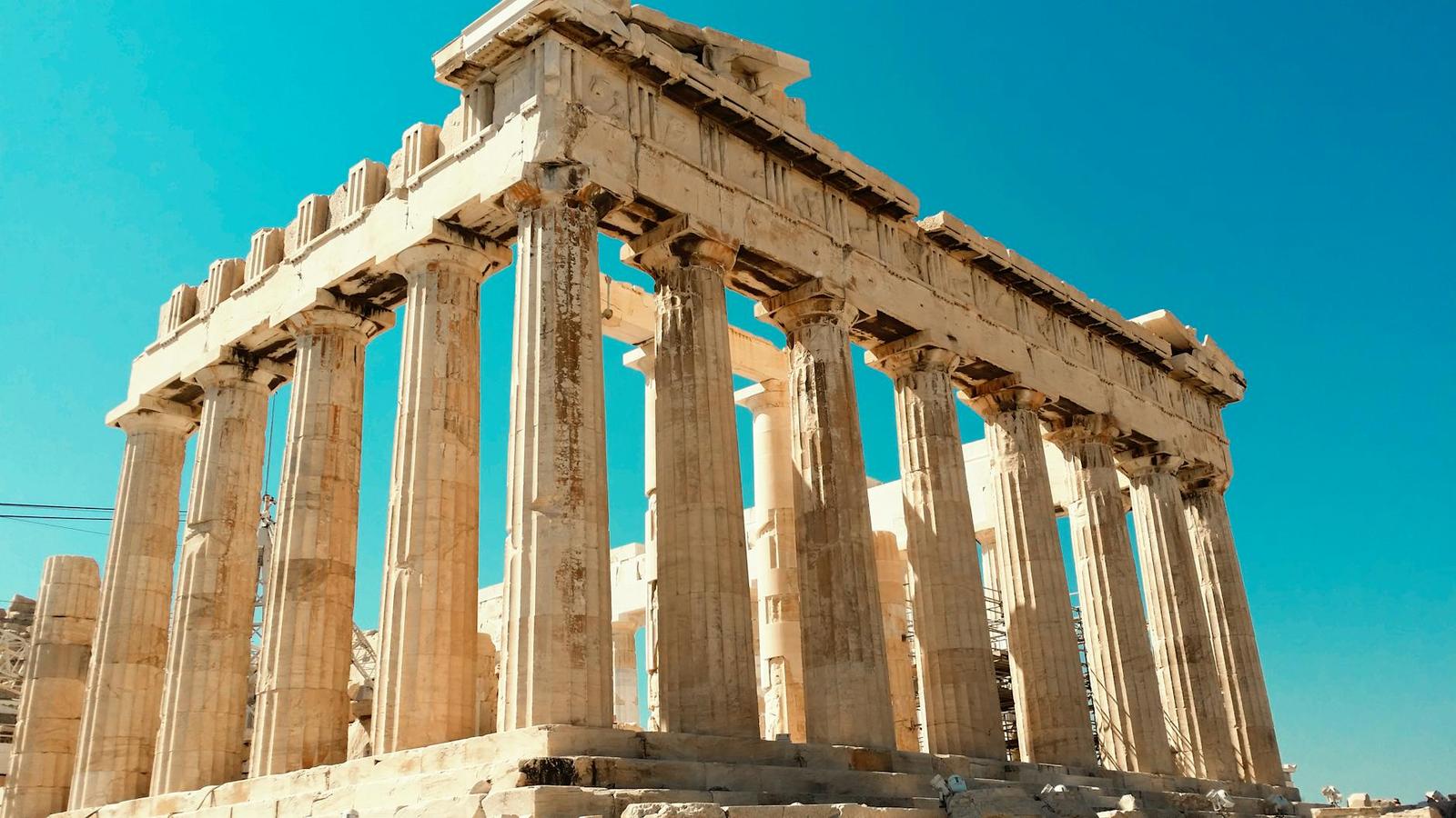 The fluted marble columns of an ancient temple against a clear sky