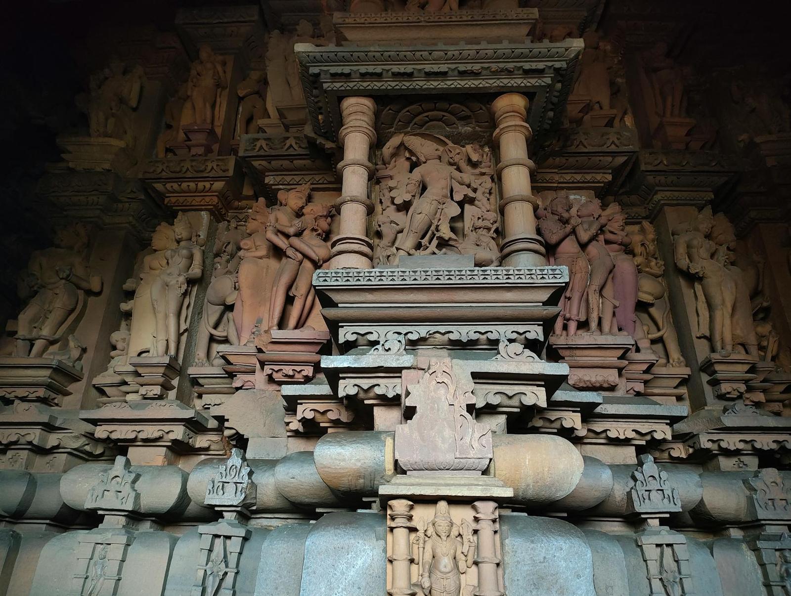 Intricately carved stone temple facade with rows of sculpted figures