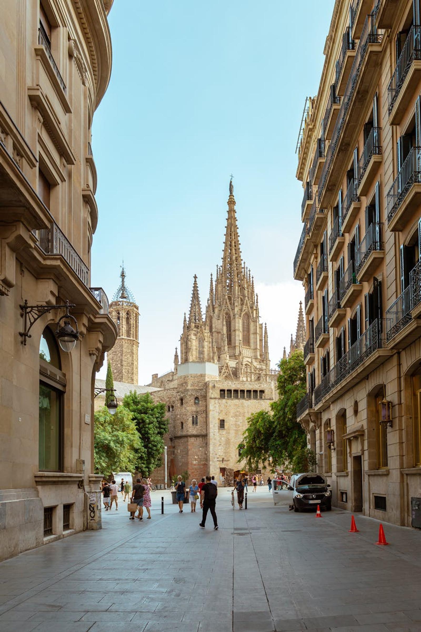 A vibrant street view showcasing the iconic Barcelona Cathedral's Gothic architecture