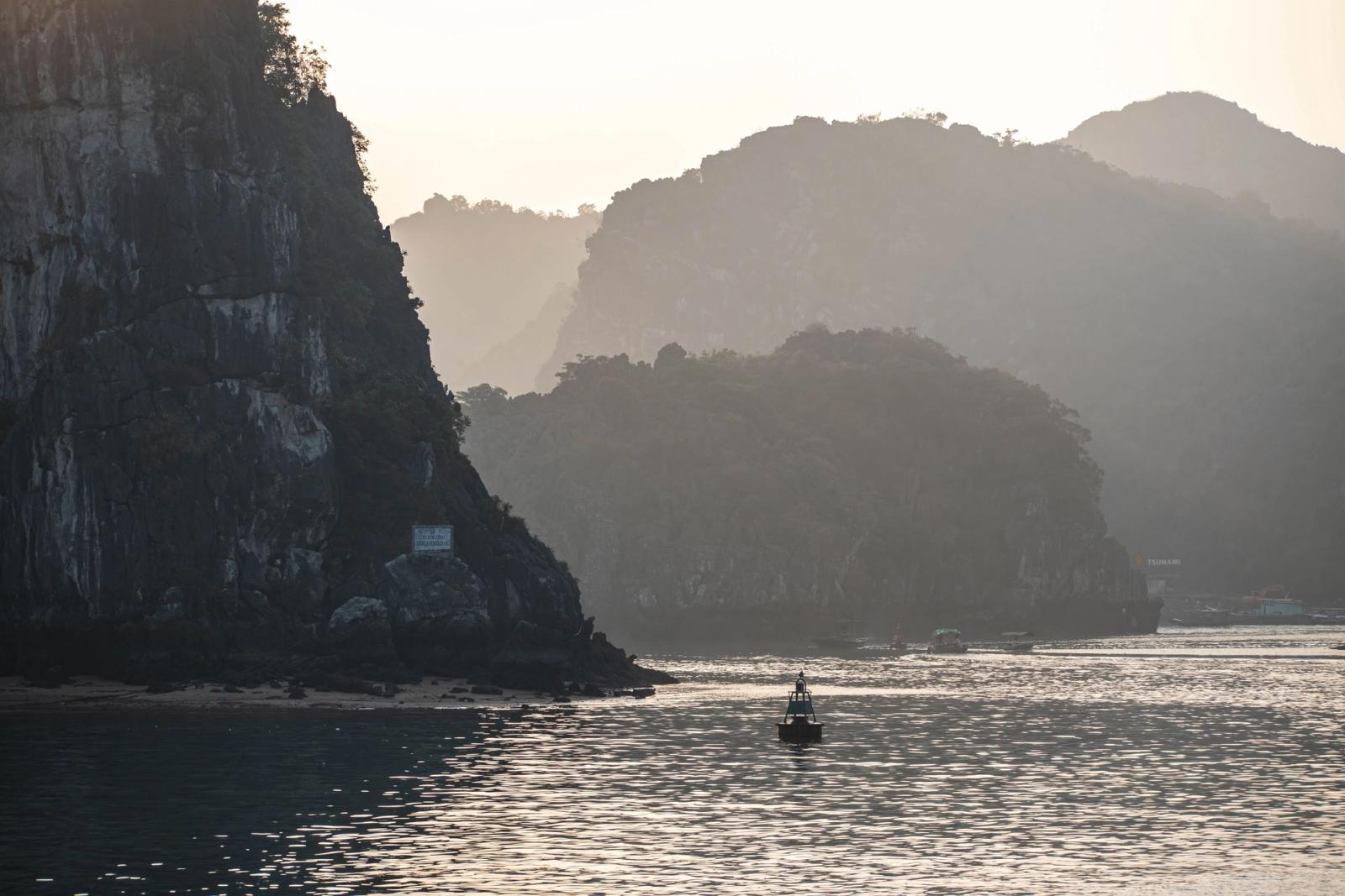 Peaceful view of Ha Long Bay with limestone cliffs in the evening light