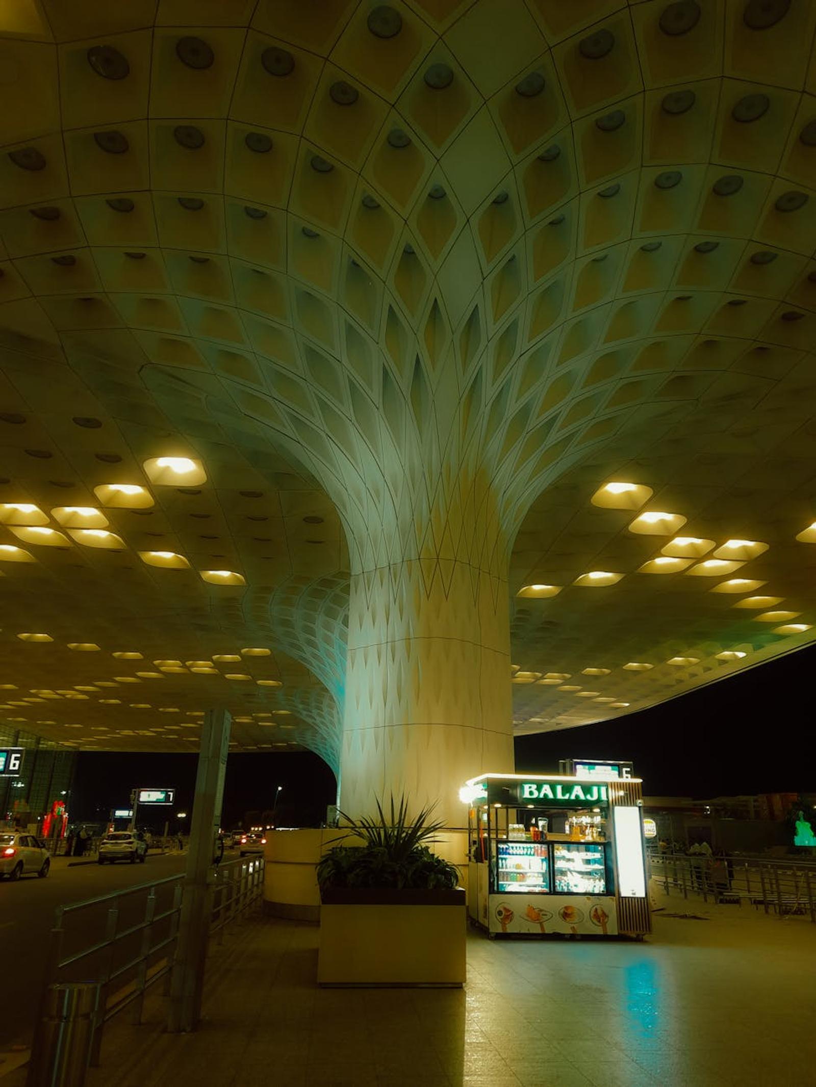 Striking night view of modern airport architecture with illuminated dishes stand in Mumbai