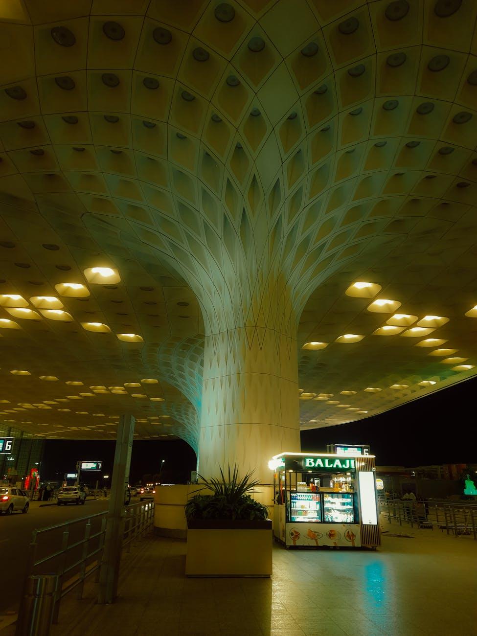 Striking night view of modern airport architecture with illuminated dishes stand in Mumbai