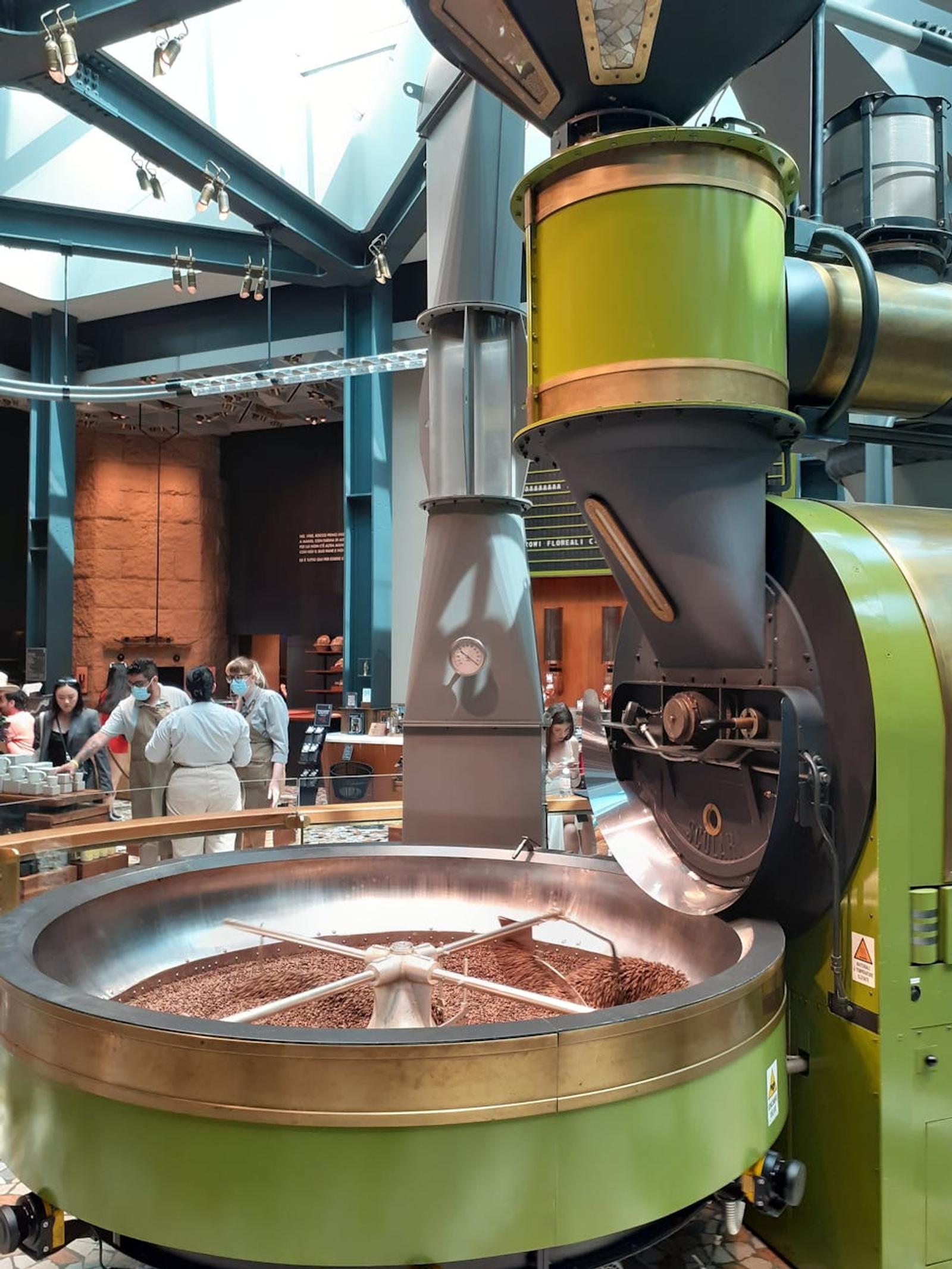 A glimpse into a chocolate factory featuring machinery and visitors in an industrial setting