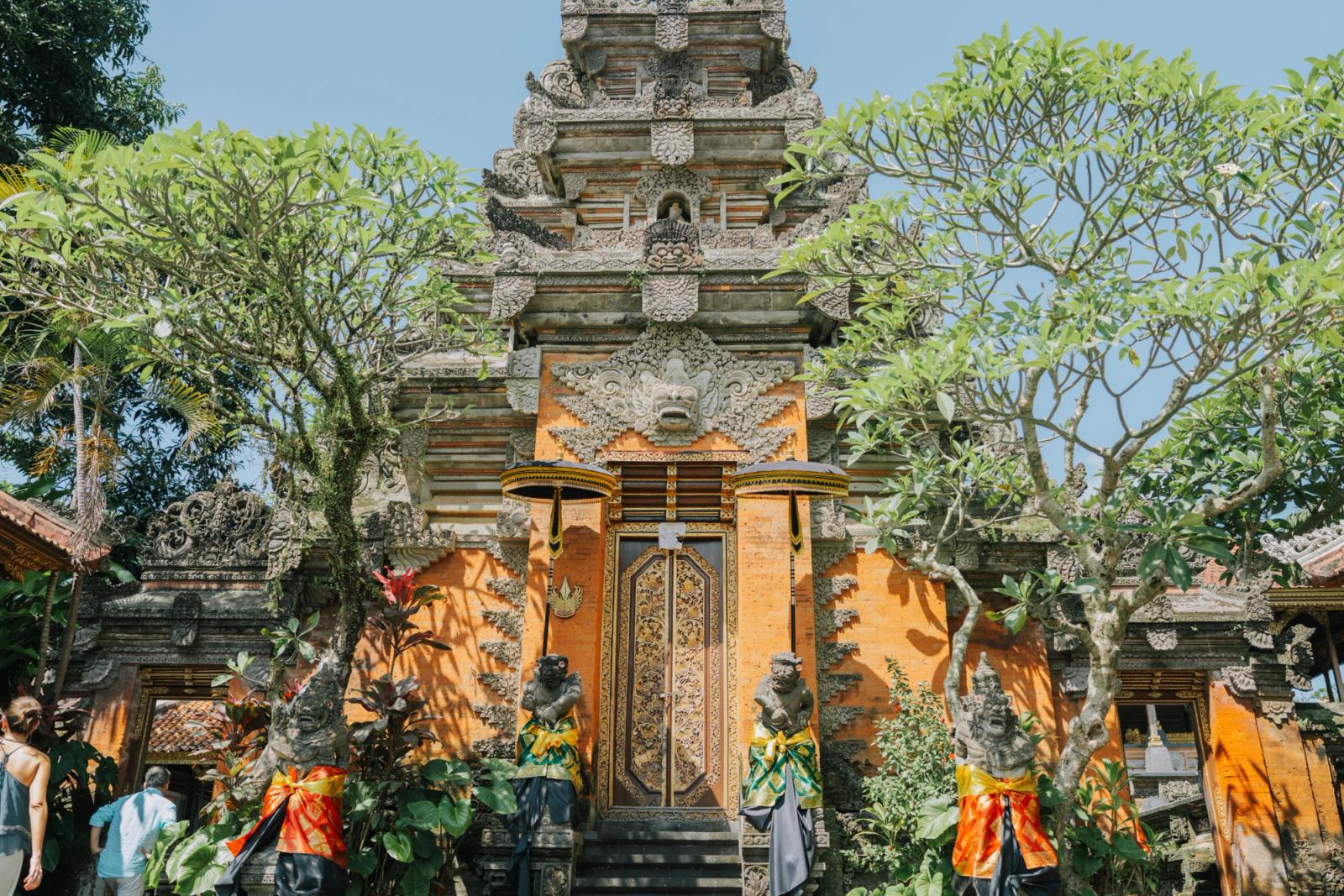Beautifully ornate entrance to a traditional Balinese temple in Ubud, surrounded by lush greenery