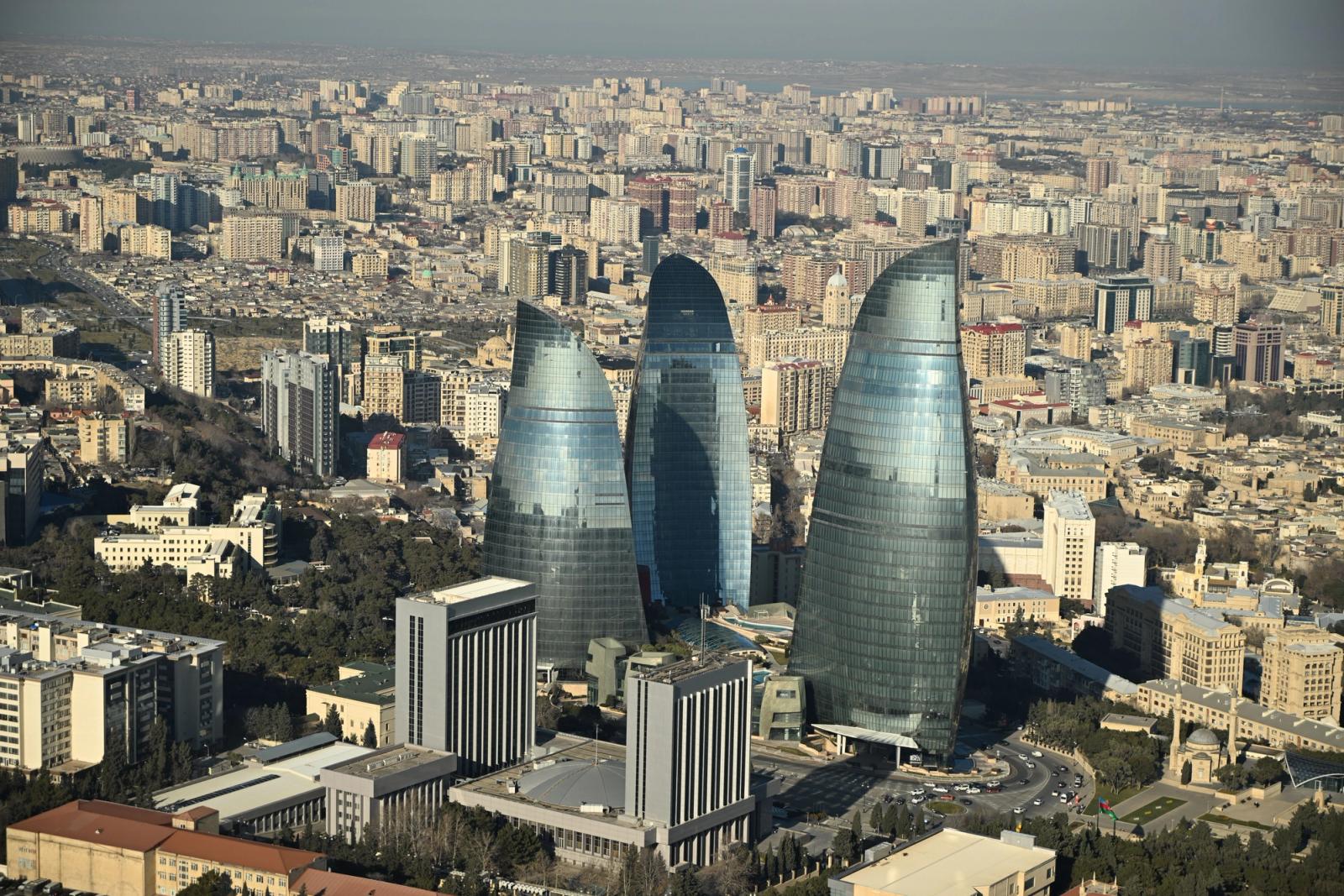 Aerial view of modern architecture featuring the iconic Flame Towers in Baku, showcasing the city's urban landscape