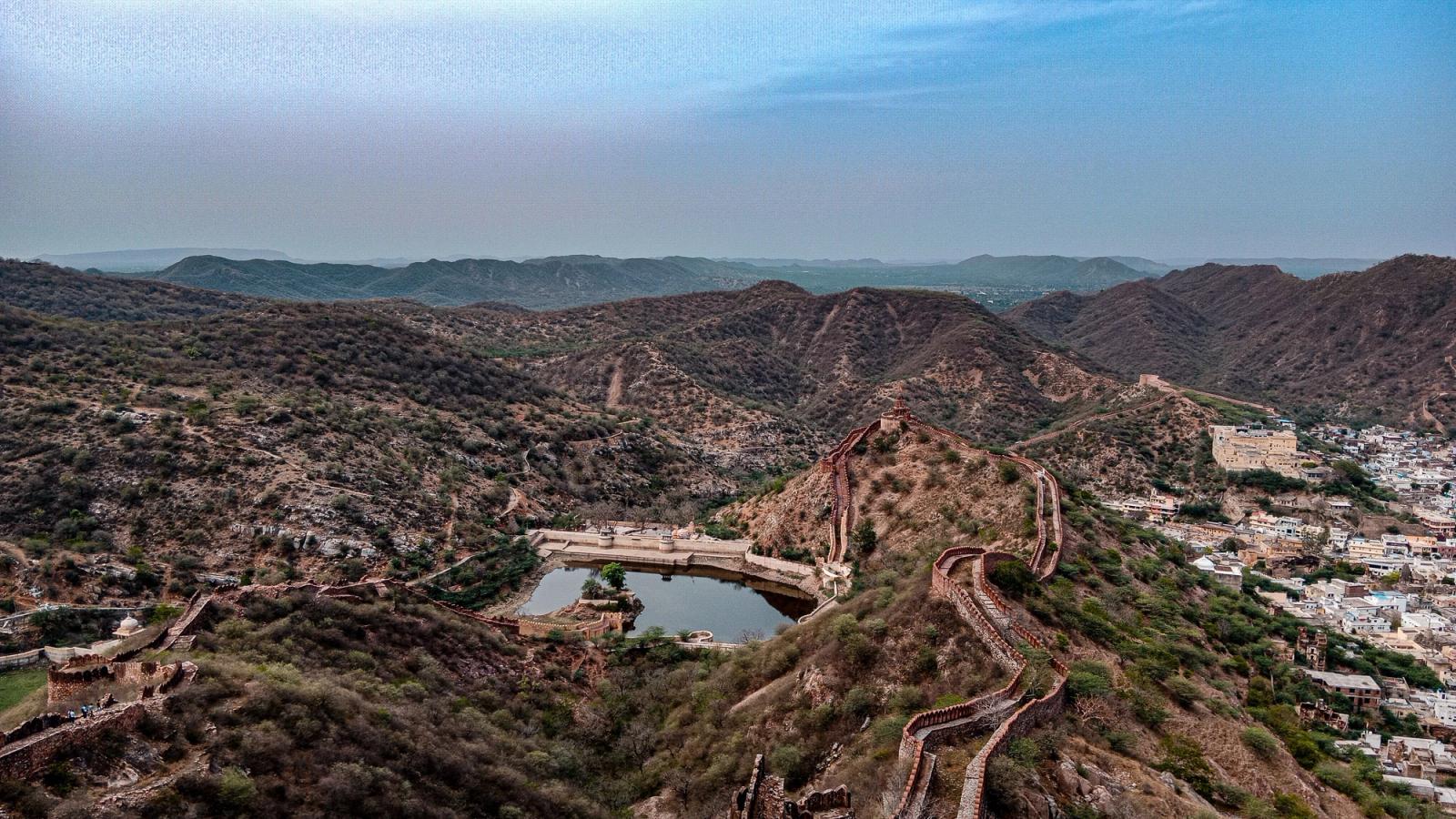 Stunning aerial view capturing Amer Fort and rolling hills in Jaipur, Rajasthan, showcasing historic architecture and natural beauty