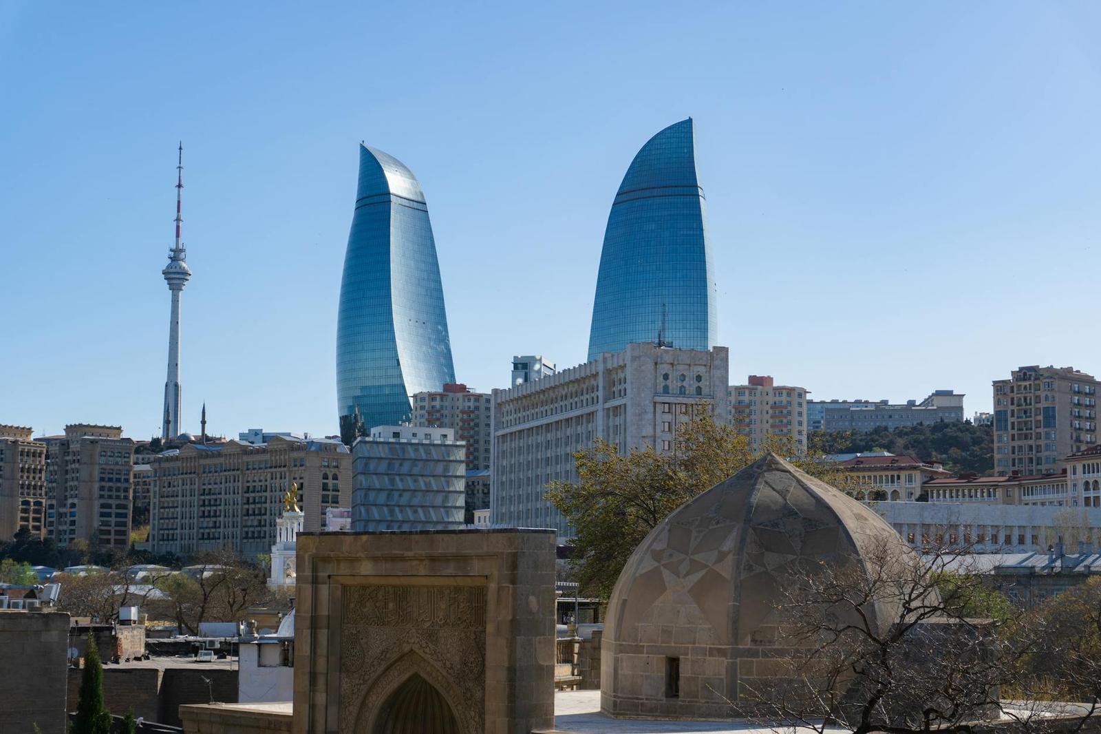 Skyline of Baku featuring iconic Flame Towers and telecommunications tower