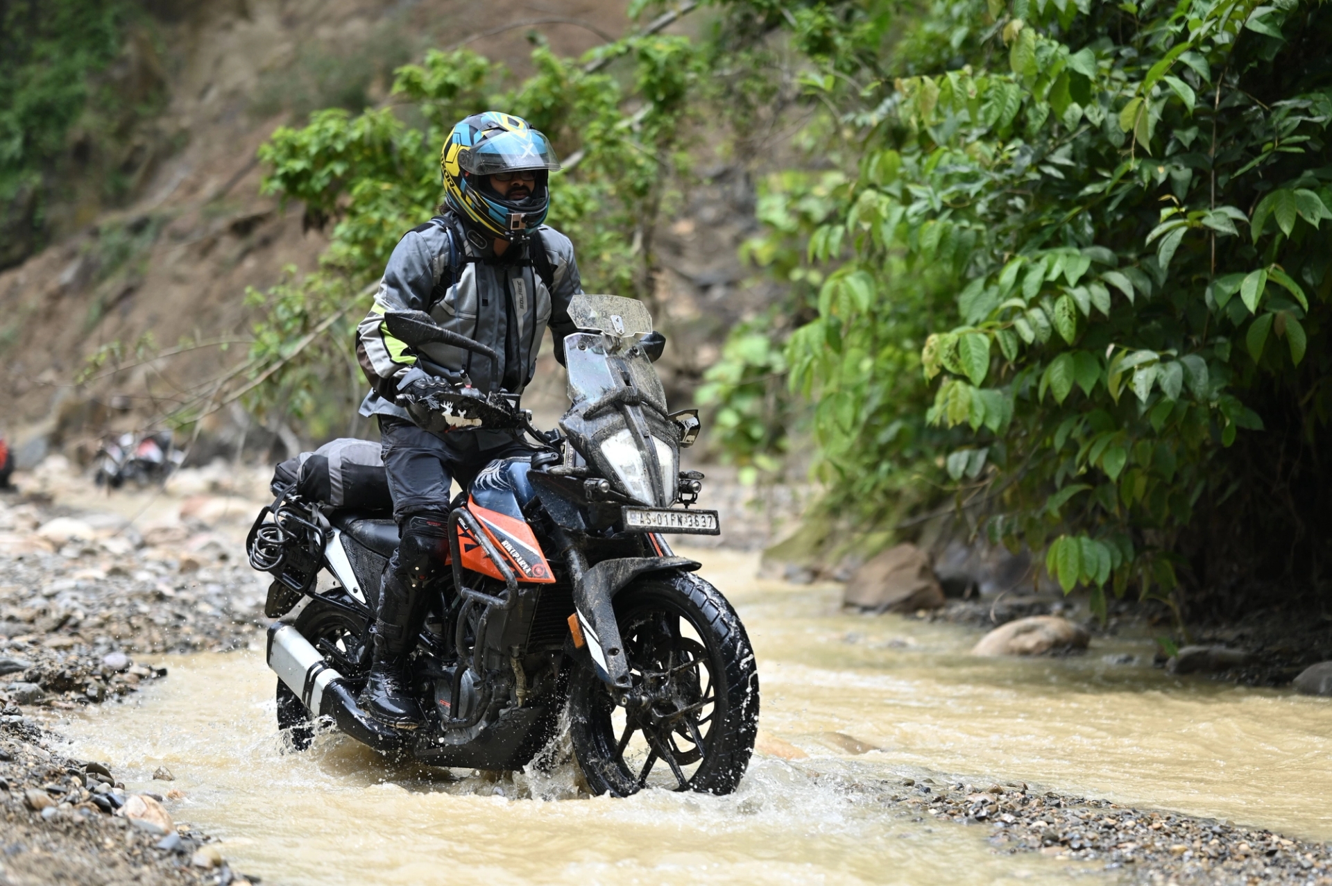 Rider exploring rugged terrain in Guwahati, India, showcasing off-road motorcycling adventure