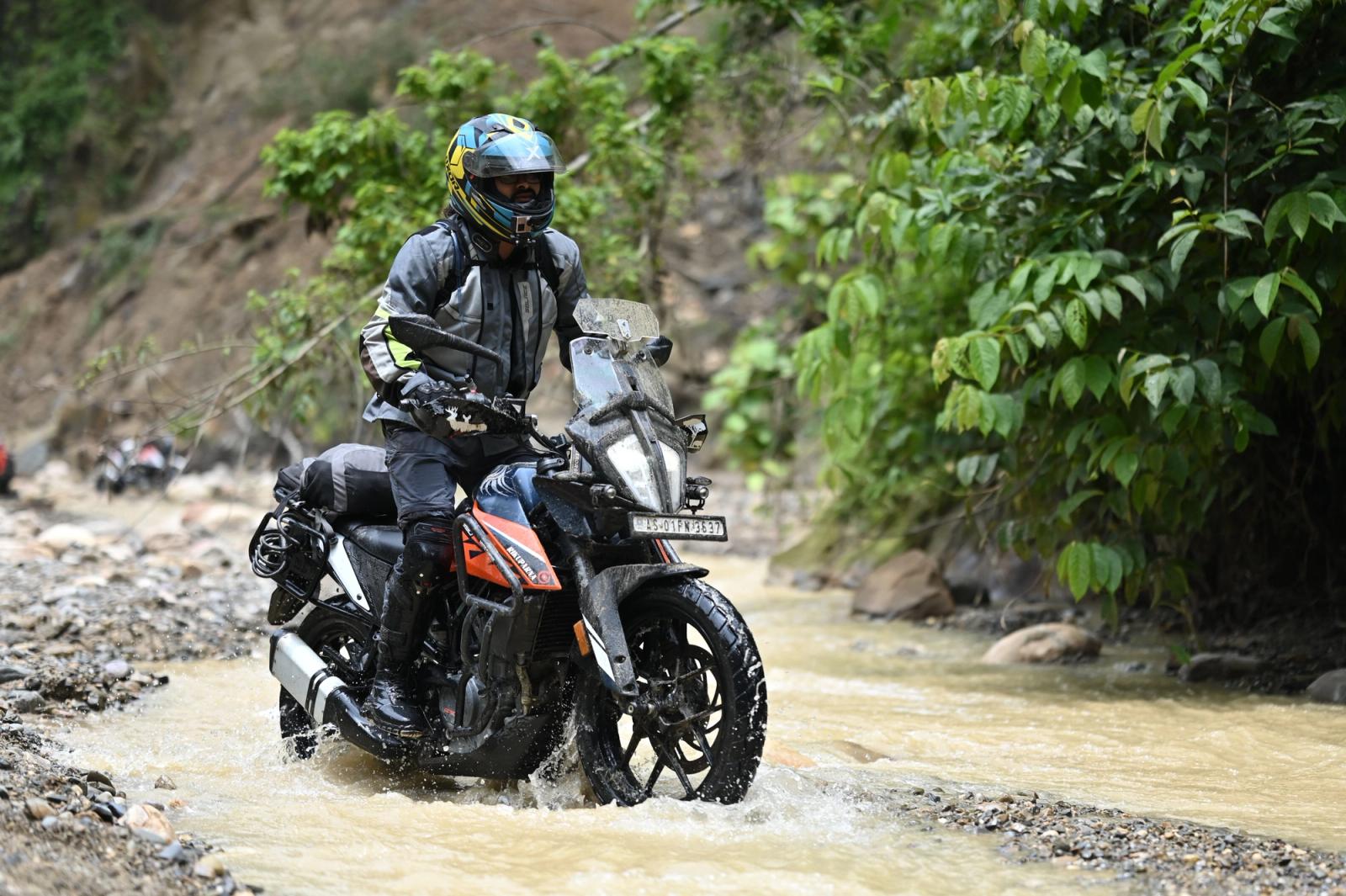 Rider exploring rugged terrain in Guwahati, India, showcasing off-road motorcycling adventure