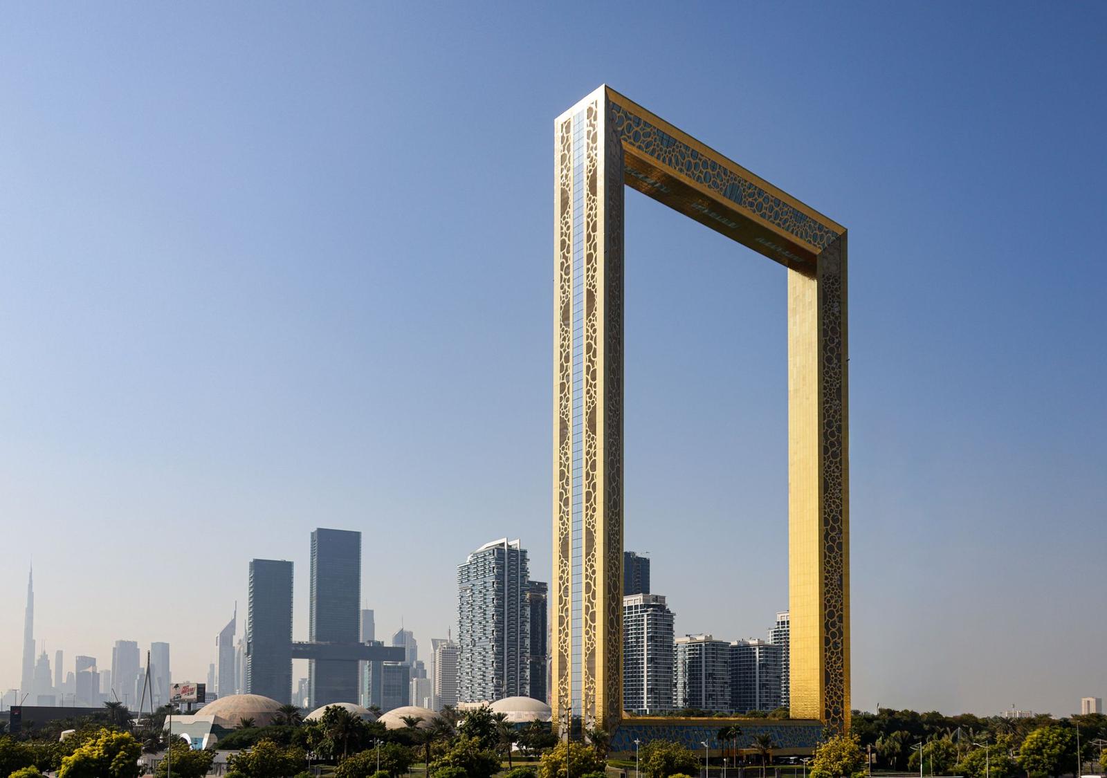 The iconic Dubai Frame with city skyscrapers in the background under a clear sky