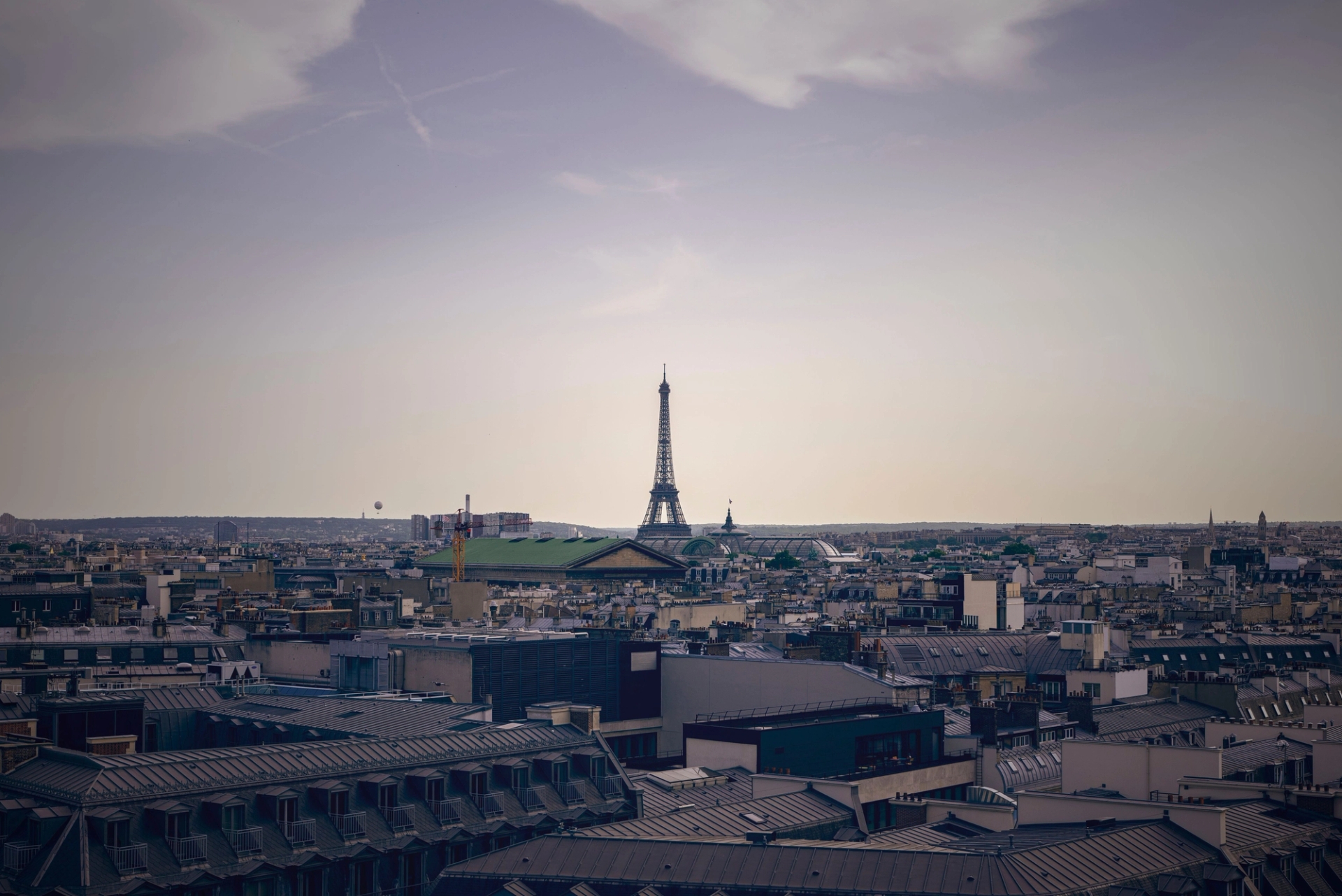 Distant view of Paris skyline featuring the Eiffel Tower against a clear sky