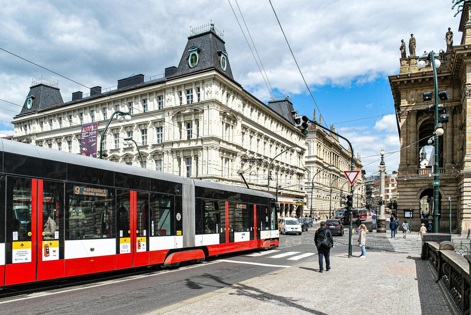 Modern tram passing by historic architecture in Prague