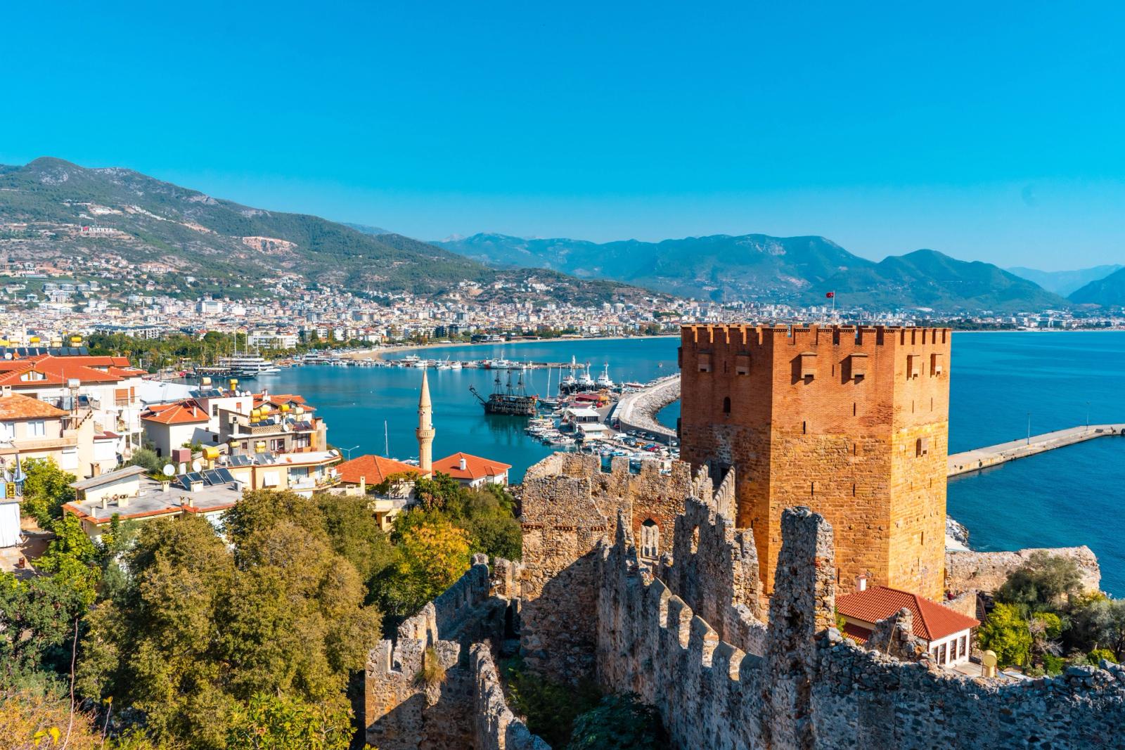 Stunning view of Kizil Kule and Alanya harbor in Antalya, Turkey with vibrant city and sea landscape